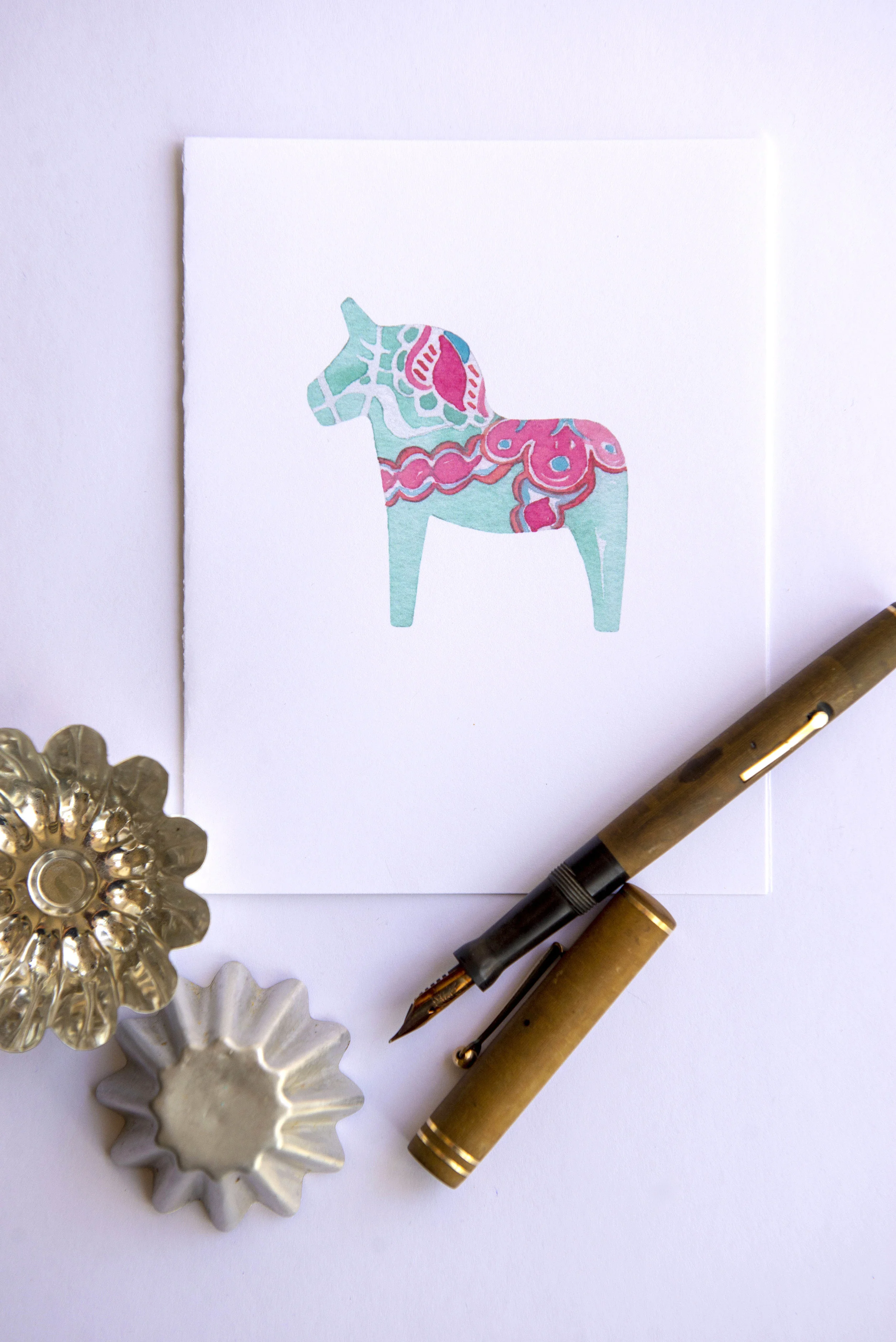 Printable watercolor greeting card featuring a blue and pink Dala horse. Download once and print again and again!  Prints (2) cards per 8.5x11 inch paper. 