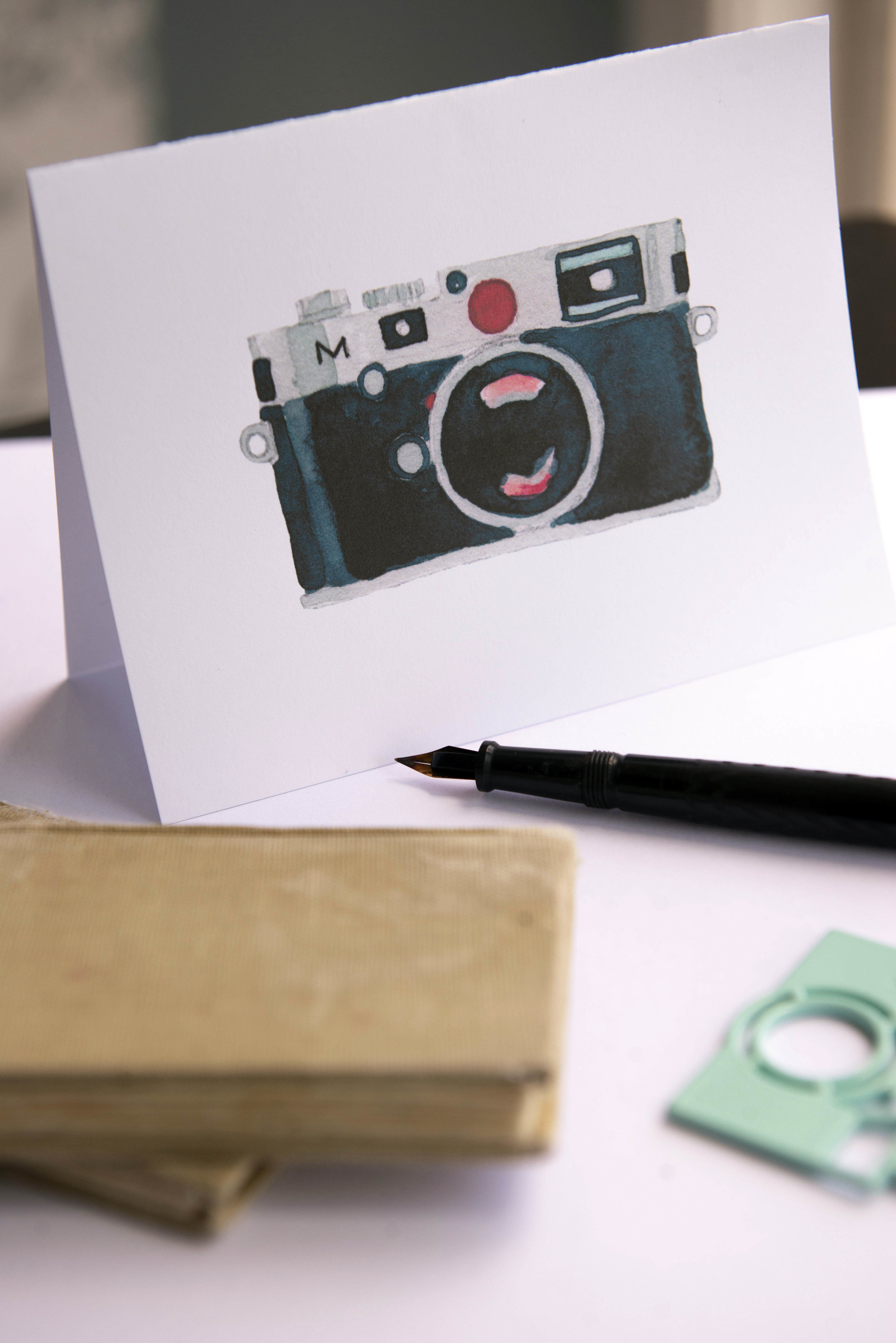 Printable watercolor greeting card featuring a black Leica film camera. Download once and print again and again!  Prints (2) cards per 8.5x11 inch paper. 