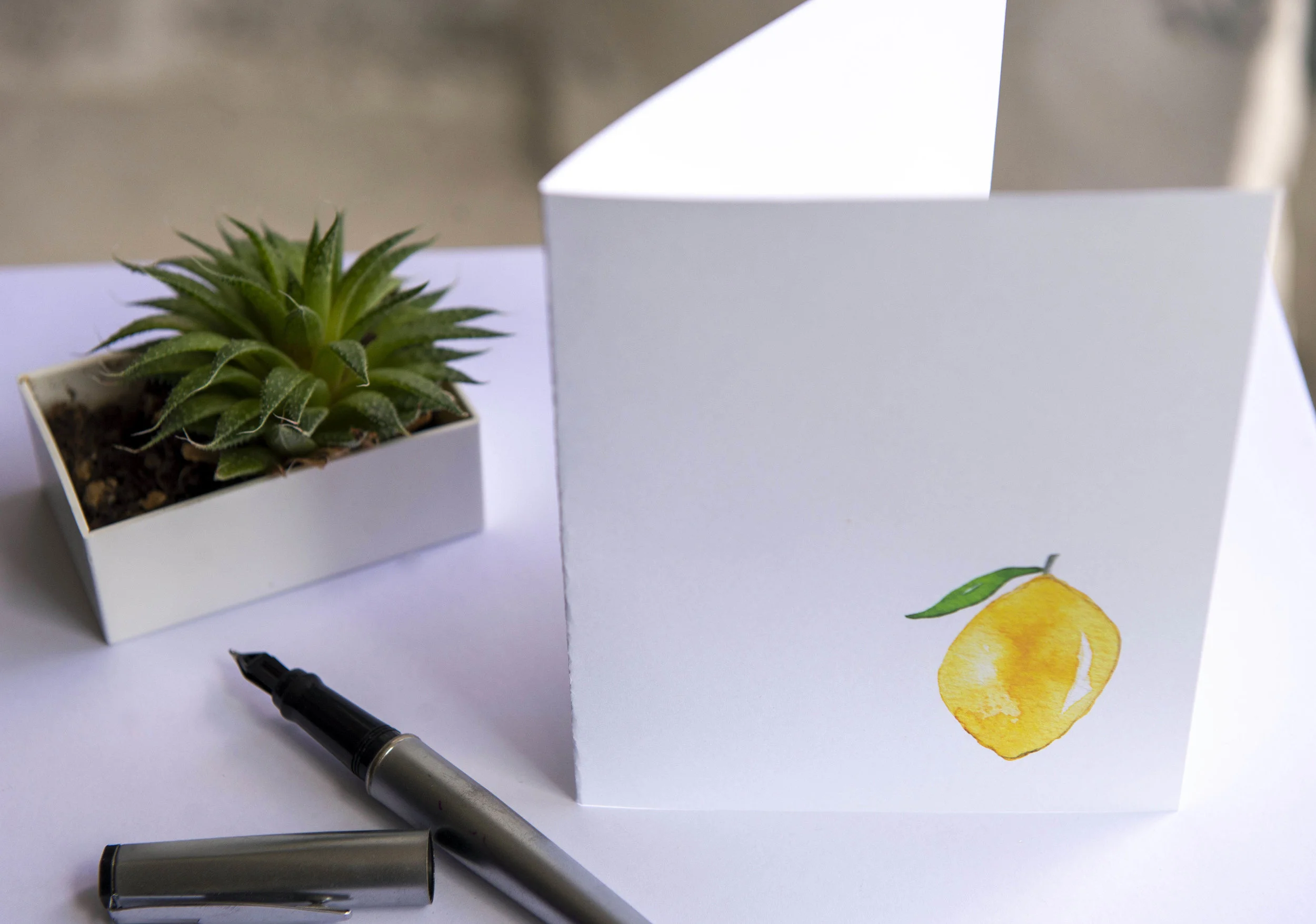 Printable watercolor greeting card featuring a bright yellow lemon in the lower right corner. Download once and print again and again!  Prints (2) cards per 8.5x11 inch paper. 