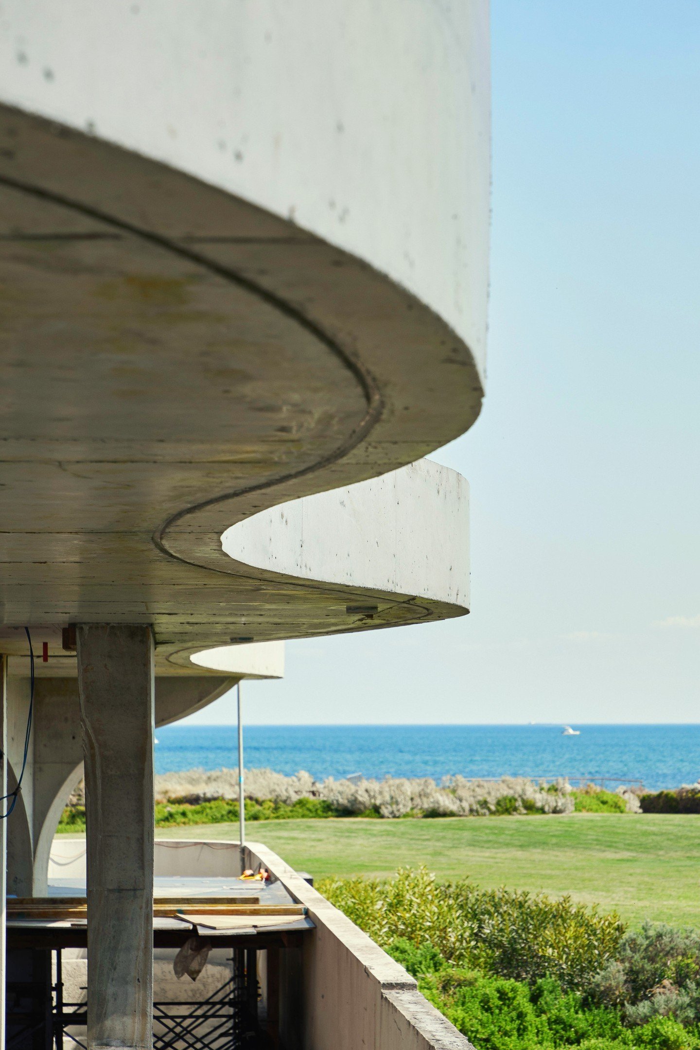 Details from J676: a curved facade, the bones of a staircase, and a room with a view.