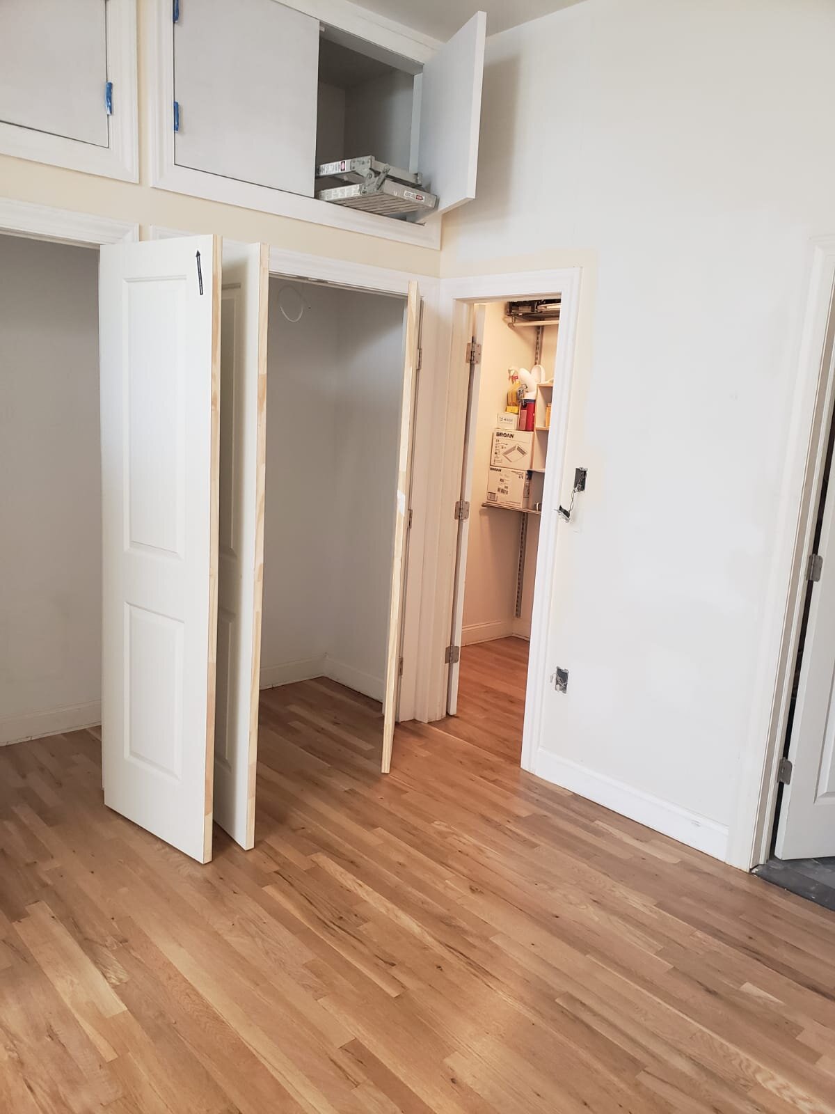 Custom closet with additional storage above