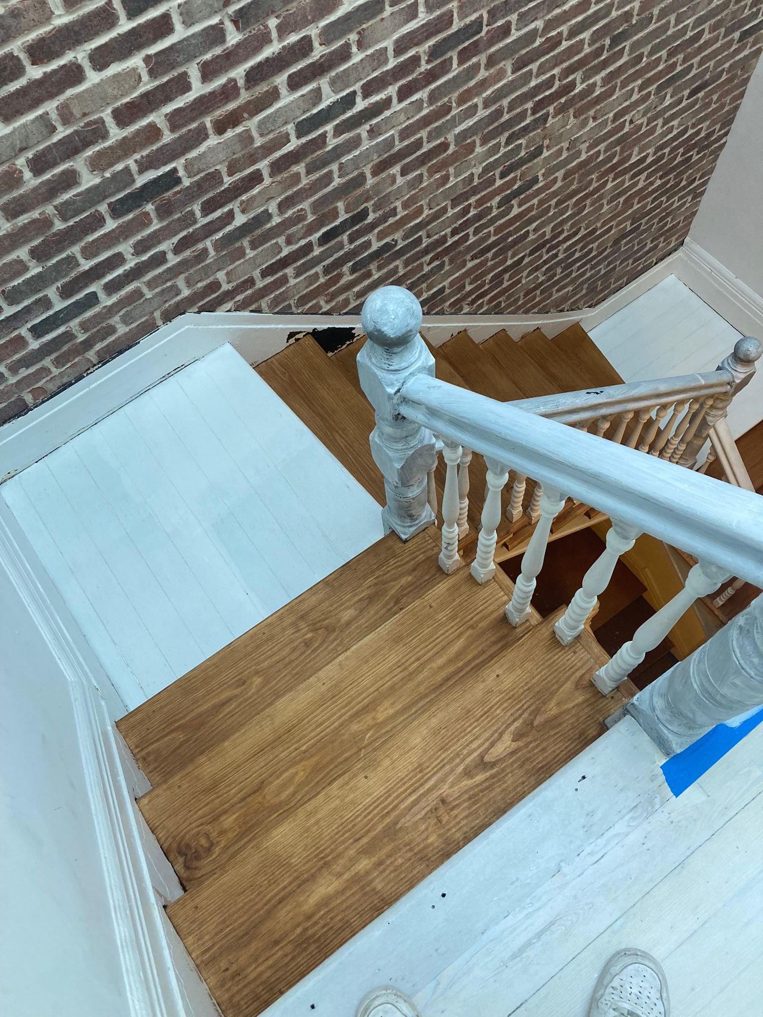 Stair refinishing and brick veneer installation 