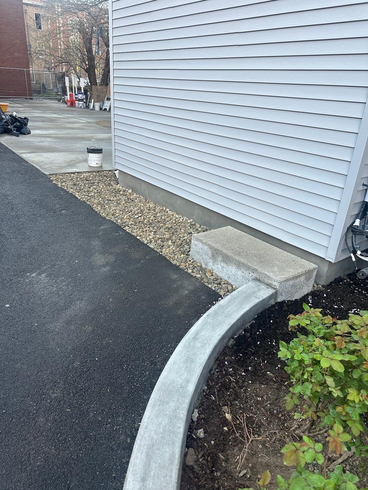 New addition to existing house with new driveway curb