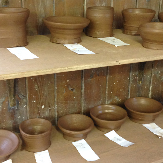 'Have a go - throw'. First-ever bowls, made by children aged 7 - 13.