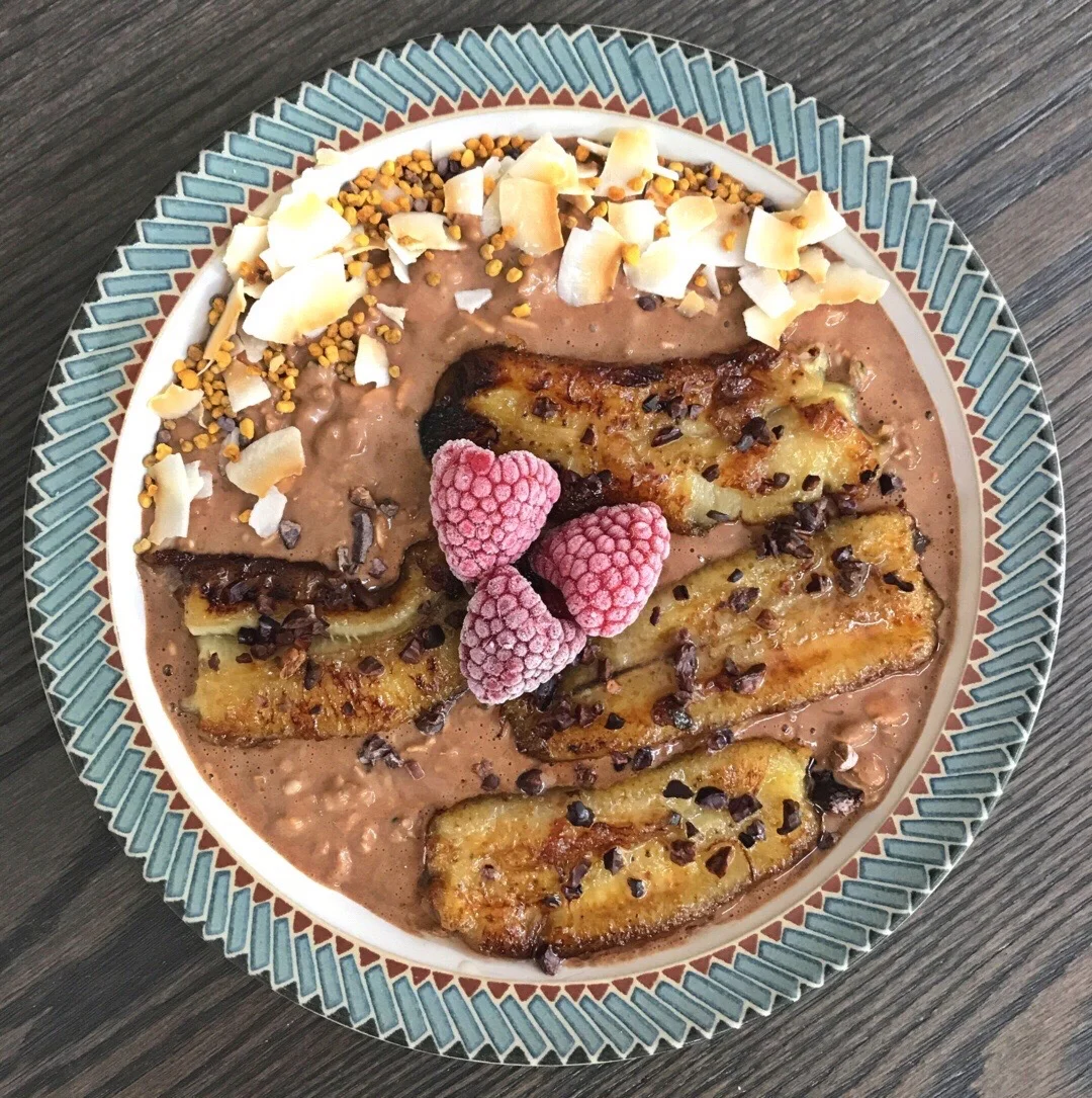 Topped here with caramelized banana (caramelized in cast-iron skillet with a small amount of coconut oil and coconut sugar), frozen raspberries, cacao nibs, coconut chips, and bee pollen.