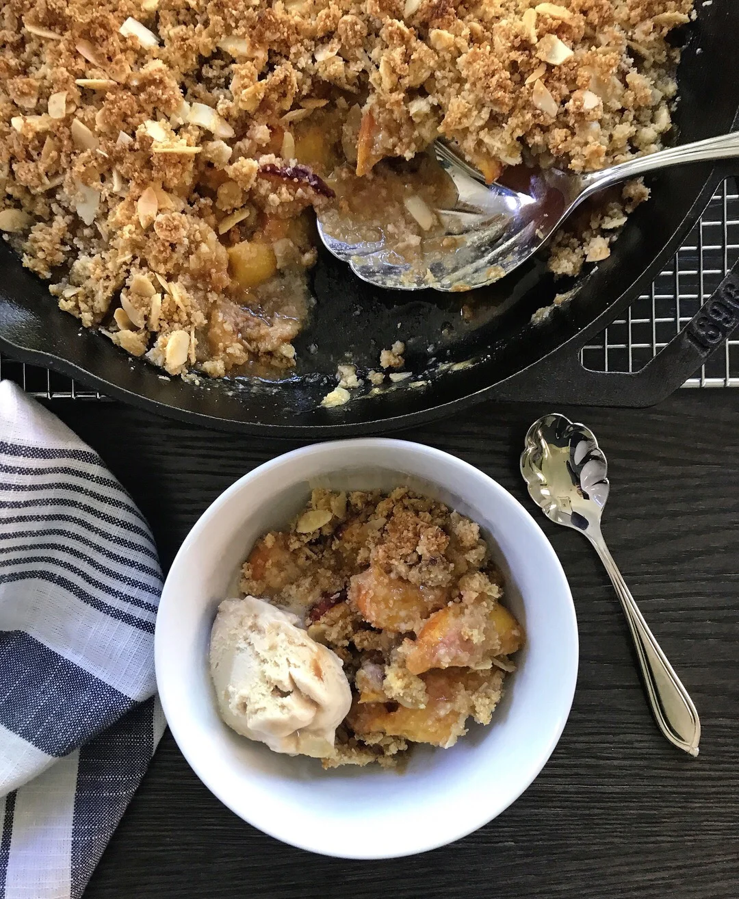 Warm from the oven Almond Peach Crisp served with vegan salted caramel ice cream.