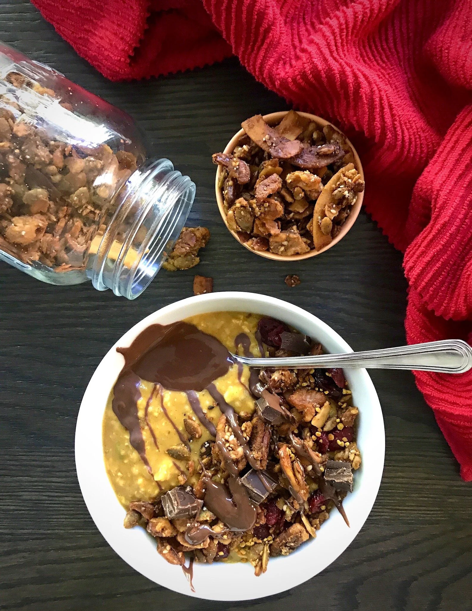 Paleo Pumpkin Spice Granola served on top of Pumpkin Spice Overnight Protein Oats along with dried cranberries, diced Giddy Yo 76% cacao ginger bar, bee pollen, and Lakanto monkfruit “Suntella” (sugar-free chocolate sunflower seed butter).