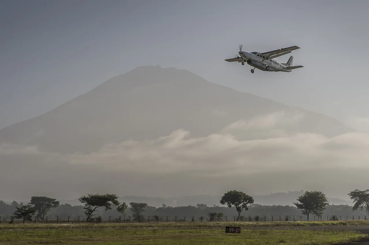 Early morning on Arusha airstrip, in northern Tanzania. A Cessna Grand Caravan belonging to a private company takes off with few tourists, for the airstrip of Seronera, an hamlet of few houses located in the heart of Seregenti National Parc, in Tanz