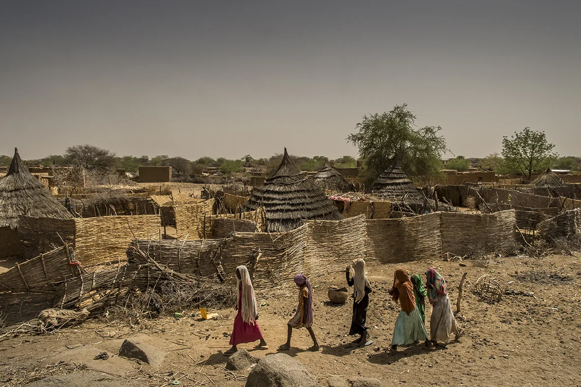 A group of young girls walk around in the village walks around in the village of Moura, Ouara district, at the end of afternoon, while the heatwave of the days has fallen back. 