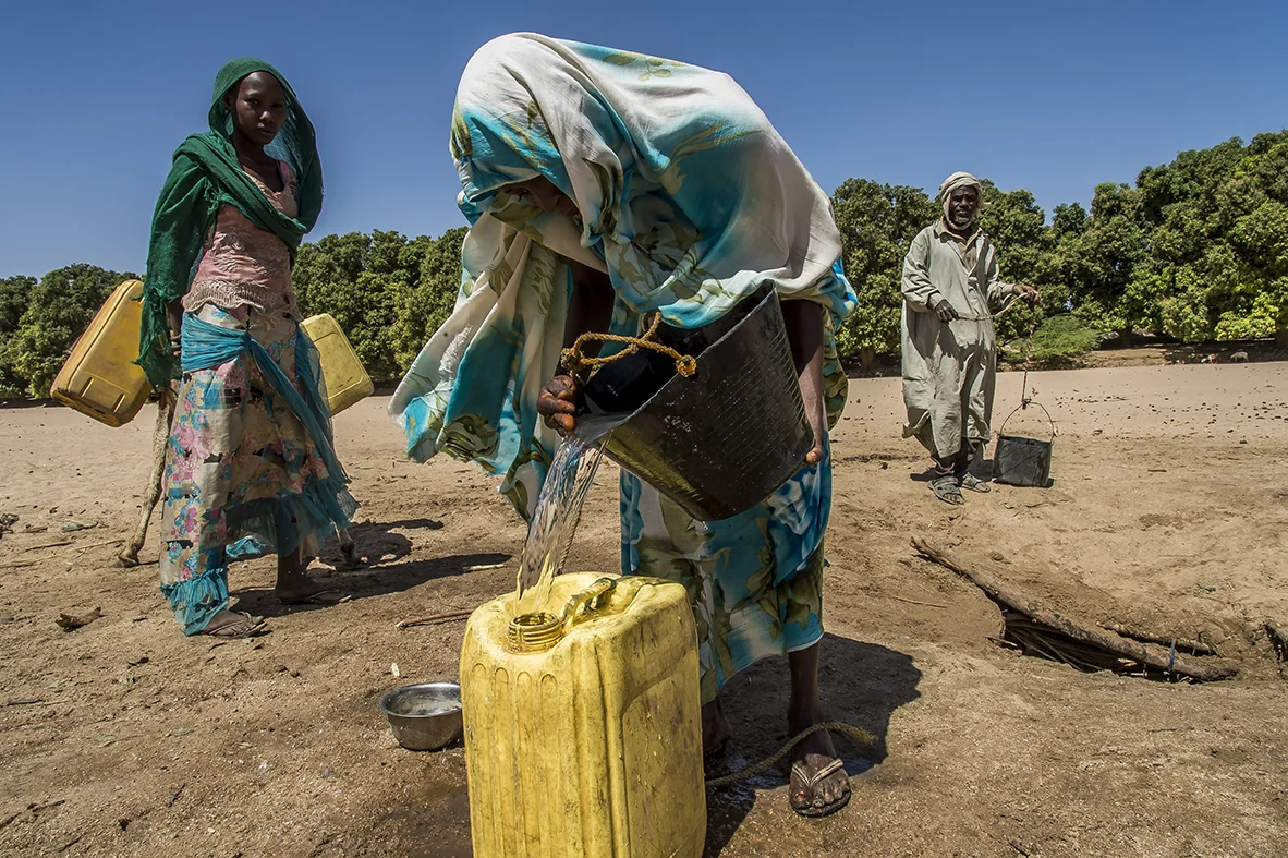 In Mourra village, Ouara district, Adjoua Abakar, 19 years old, mother of two girls (23 months old Intizar Youssouf and two years and a half Halima Youssouf) fills a jerrican with water collect from a well in the middle of a wadi next to her home. Her husband has left 2 years ago to work in golden mines in the Tibesti, the far away northern region of Chad. She did not get any news since. He does not send any money. Intizar suffered from severe malnutrition and is still monitored bu the Health Center. To earn some money, Adjoua Abakar sells grilled grasshoppers in the near-by market. 