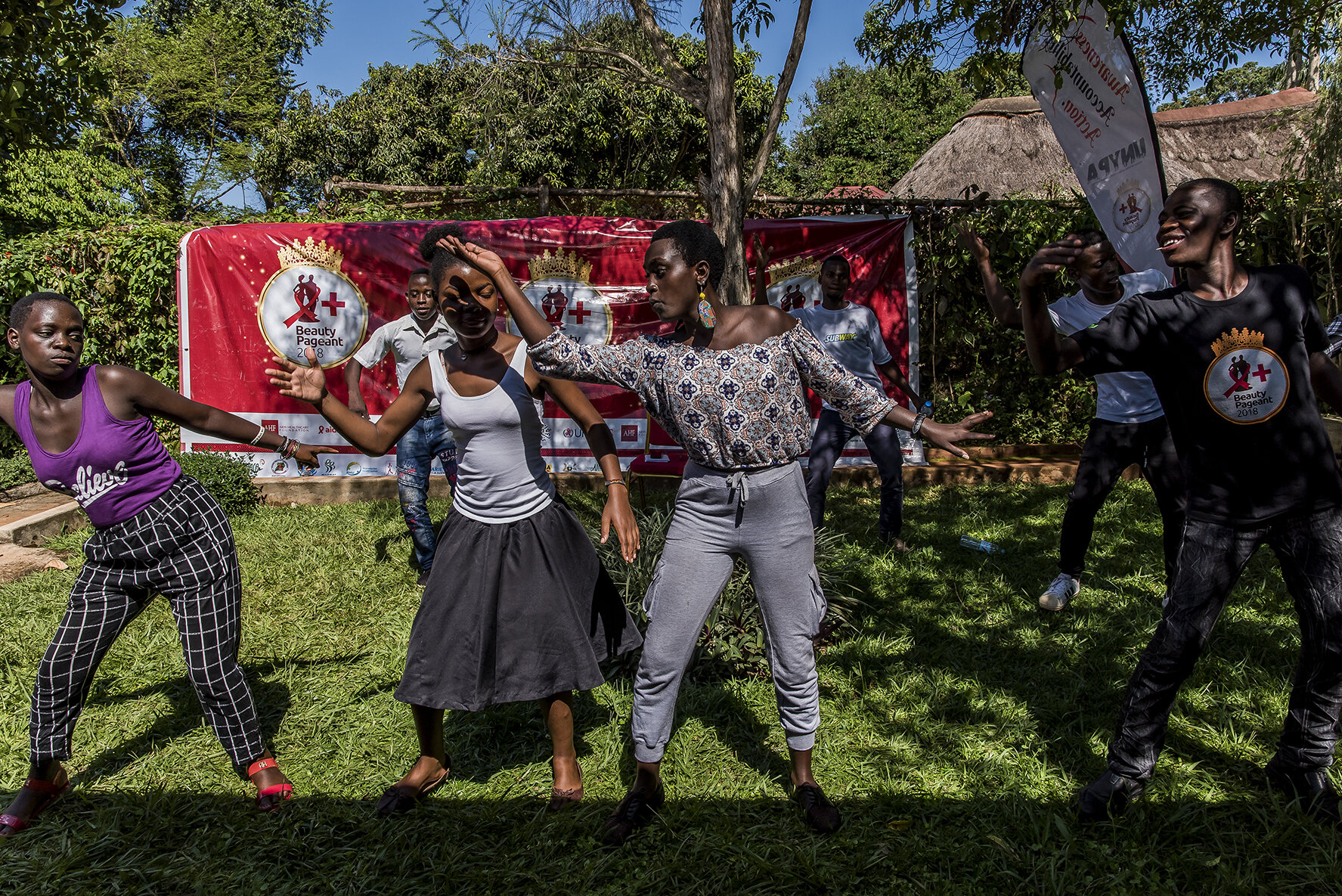 Finalists for the Y+ Beauty Contest informally rehearse the parade opening choreography during a four-day training retreat held at Banana Village, a hotel on Lake Victoria. Vivian Nabanoba, the future winner of the competition (in gray, in the middl