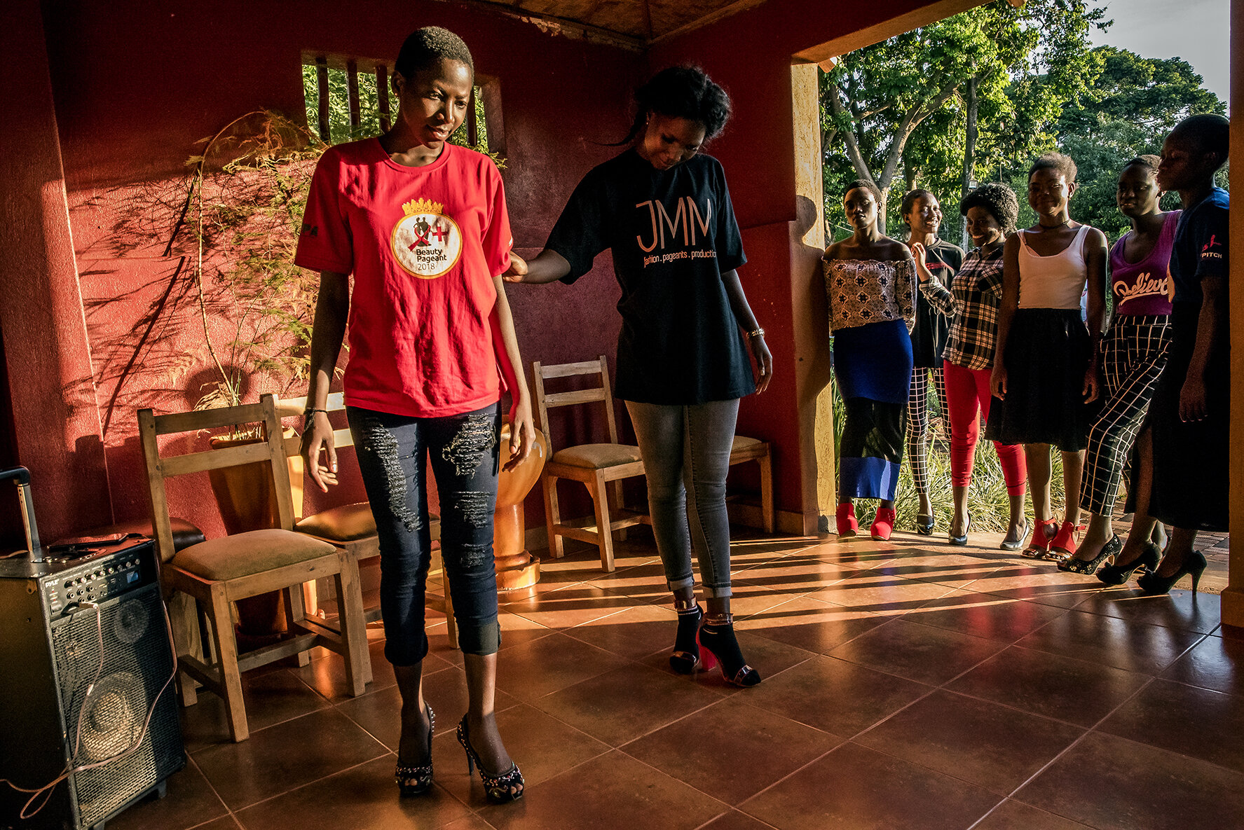 A professional coach expert in fashion shows teaches female finalists how to walk with high heels during a training retreat in a resort on Lake Victoria in Entebbe. The Y+ beauty contest is national. In previous months, auditions were organized in t