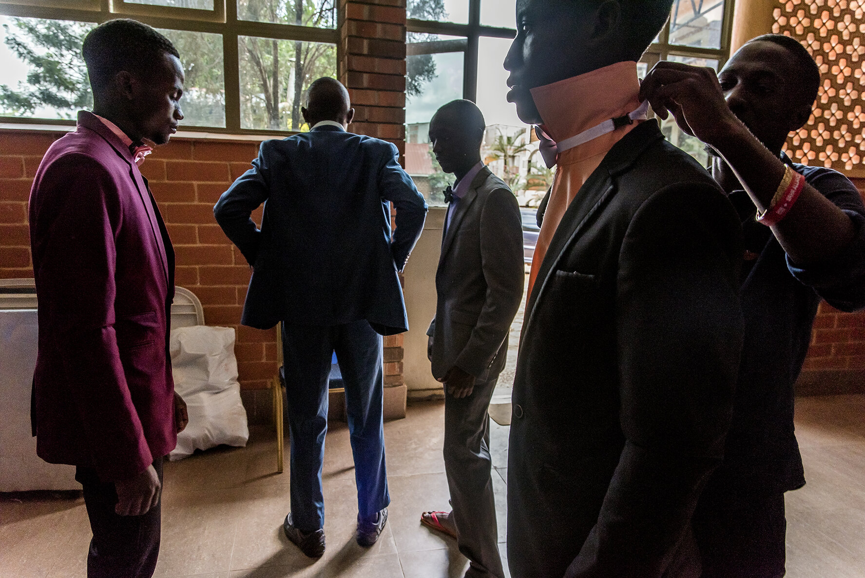 Male candidates put on their suits during the adjustment and fitting session the day before the competition in a common room adjoining the hotel where they spend the night before the final.