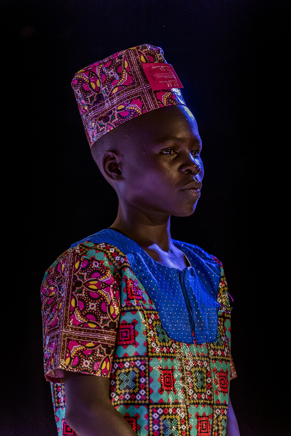 The young Acholi ethnic candidate from northern Uganda is wearing the costume he made for the message test. On his cap, a condom is stapled, reminding to the audience of the need to protect themselves during sexual intercourse in order not to contra