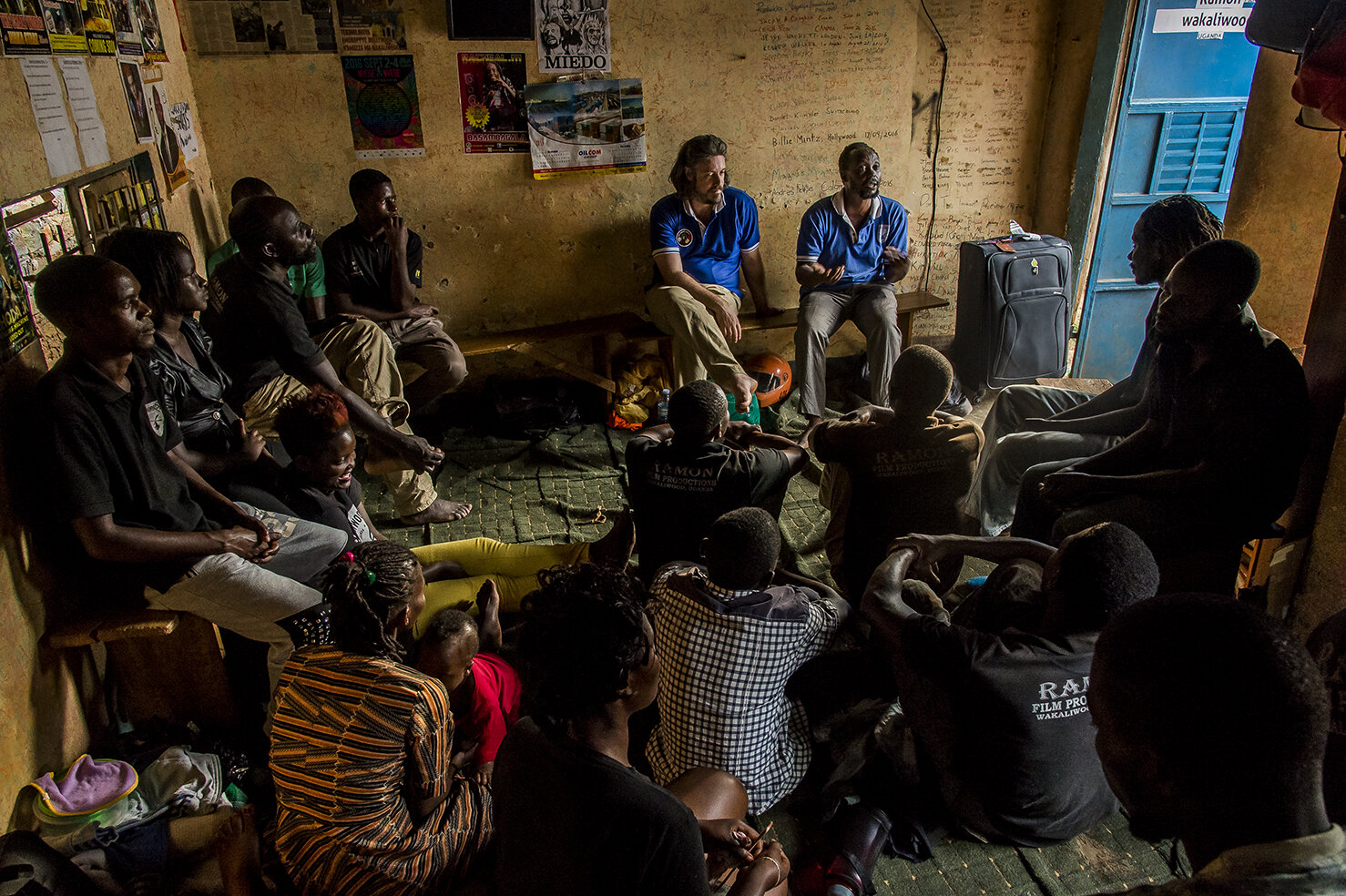  When the shooting days are over (Wednesday &amp; Saturday usually), Wakaliwood’s actors sit in the rehearsing and stocking room and listen to Isaac while he drones out the news and the planning of the shooting to come and speaks of any issues. Wakal