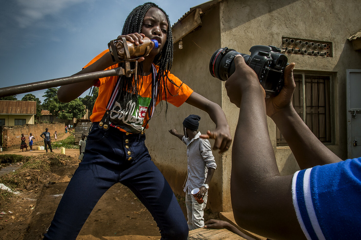  While her father, Isaac Nabwana shoots her, Racheal M. Natembo, dances and mimes the lyrics of her latest song, during the shooting of the video clip in the family compound. 