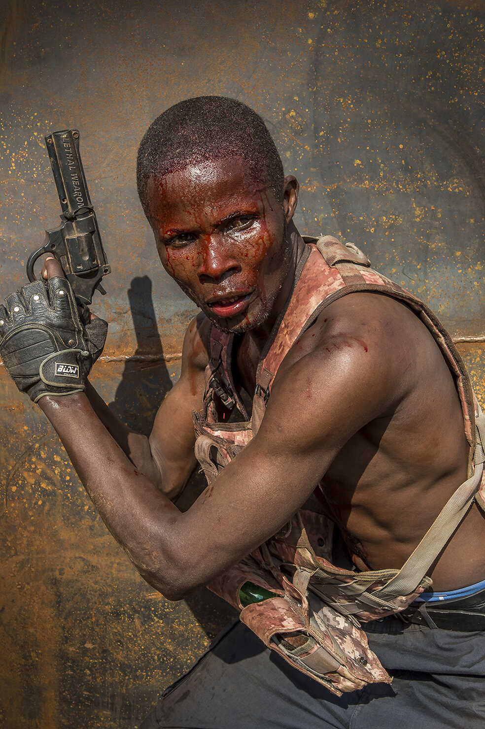  Charles Bukenya, Martial Art teacher, actor and stuntman in Wakaliwood. His work in cinema is inspired by Bruce Lee and the Chinese movies. His face is covered with fake blood, food color mixed with water. In the past, the blood was real cow blood w