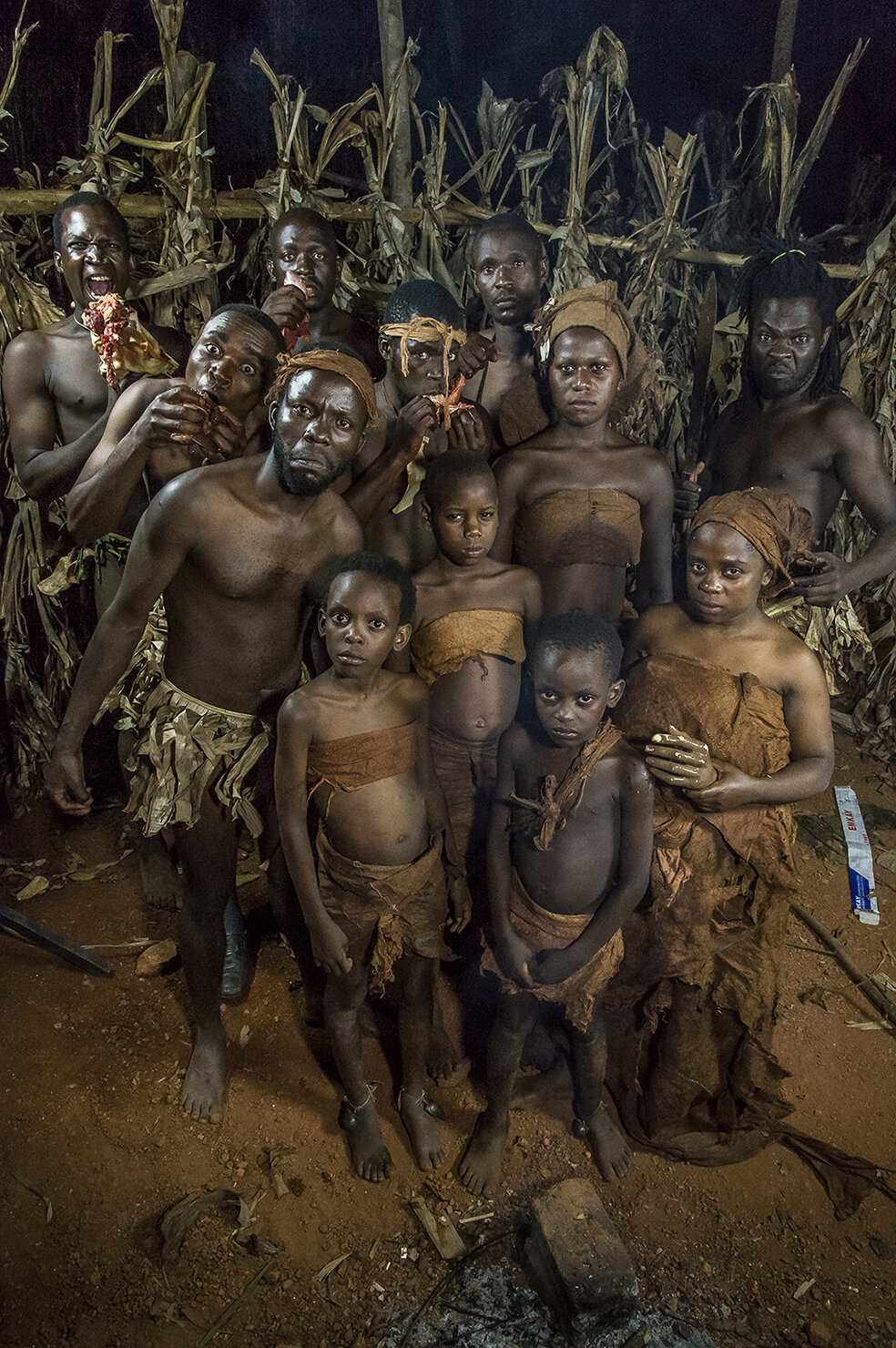  Kaliti village, 30 kms away from Kampala. Family picture of actors of Ramon Studio, in cannibal outfits. On the land of the mother of one of the comedians, Isaac Nabwana shoots all night long, in the bush « Eaten alive » a movie inspired by a cannib