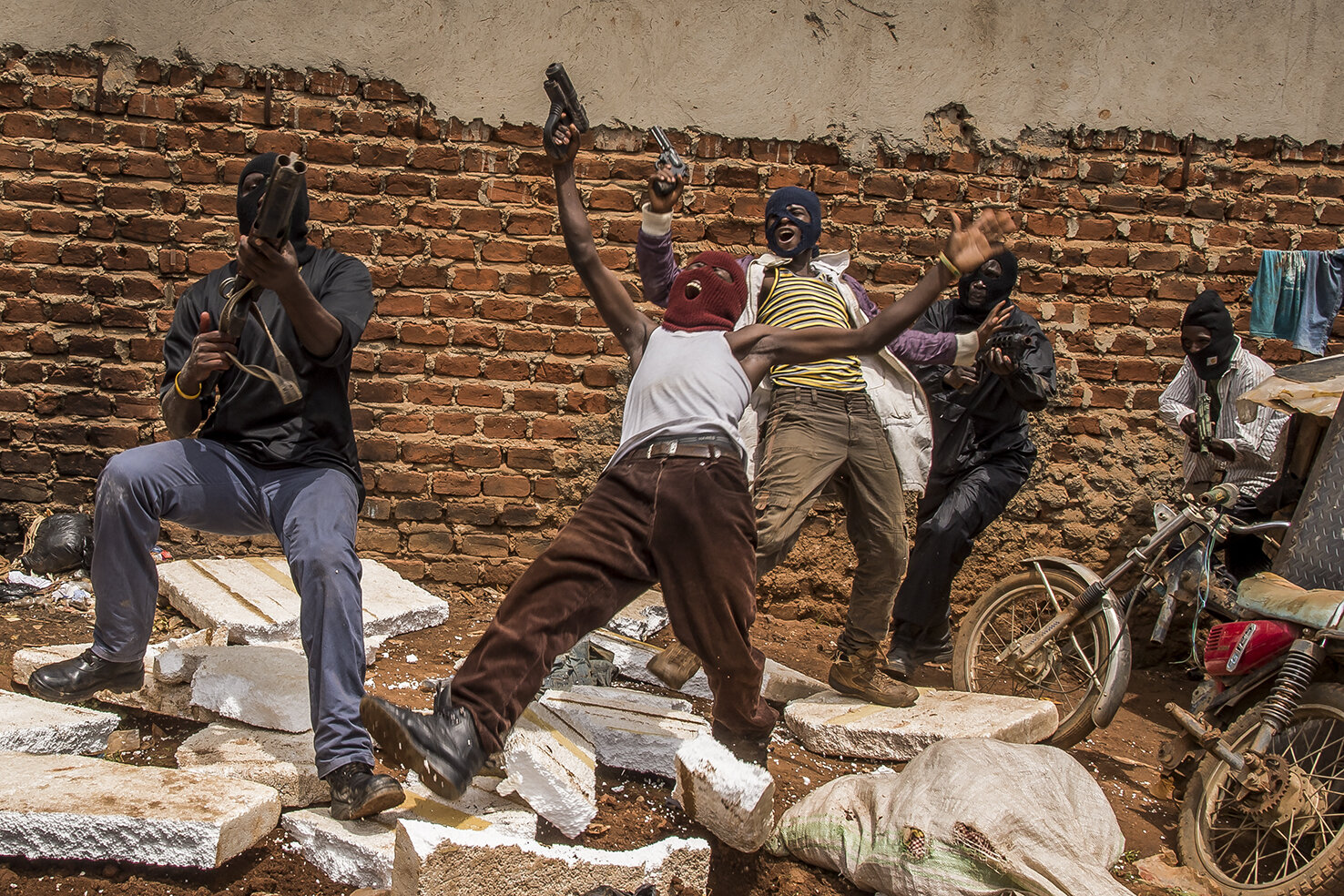  A part of the gang of hoodlums killed during the shooting of « Operation Kakongoliro » (Very dangerous operation) « The Ugandan Expendables » in a corner of the family plot of Isaac Nabwana in Wakaliga. ICG will add some sound effects and special ef