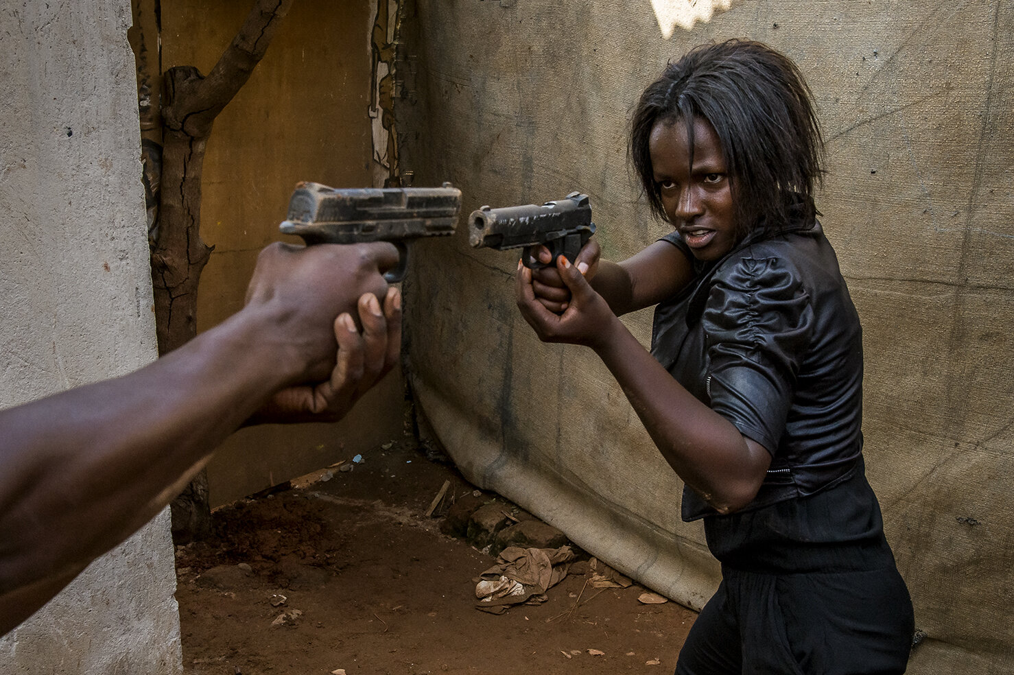  Ritah shoots a scene on a set, figuring a jail, built in the family compound of Isaac Nabwana, the soul, creator and director of Wakaliwood. She is the first ever heroine of Wakaliwood, the main character in « Who killed Captain Alex » a TV series, 