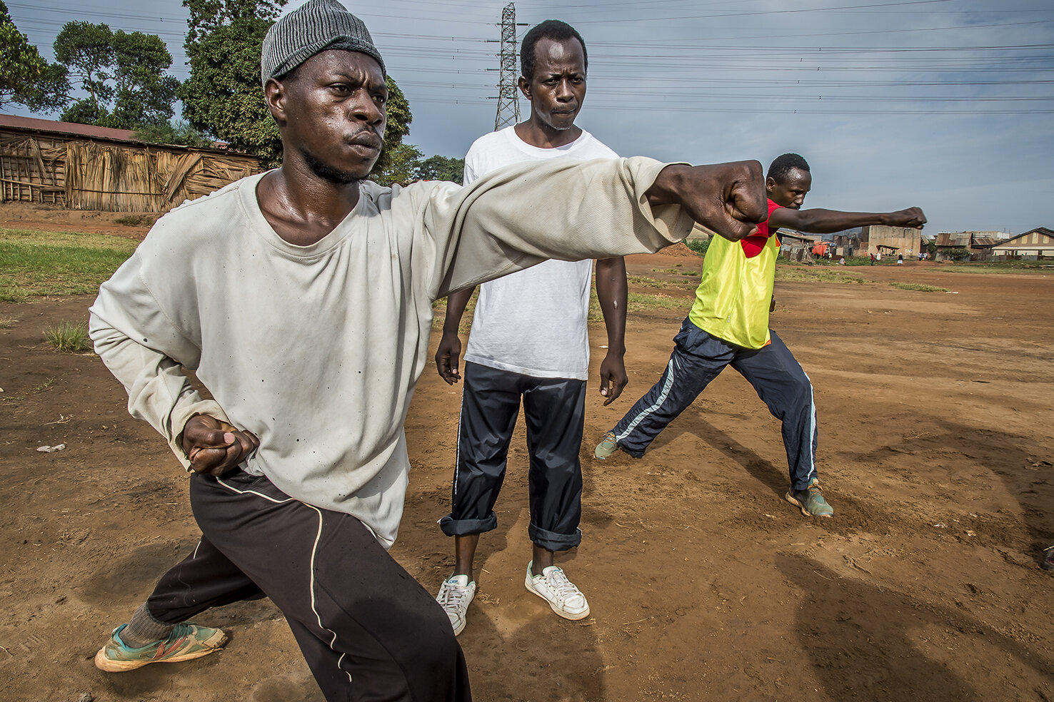  Half-brother of Isaac Nabwana, the director/producer of Wakaliwood, Robert Kizito (white teeshirt) gives his Kung Fu class every Sunday on a football pitch in the out of the way area of Natete. Amongst the assistance, Wakaliwood actors Kasekende Mus