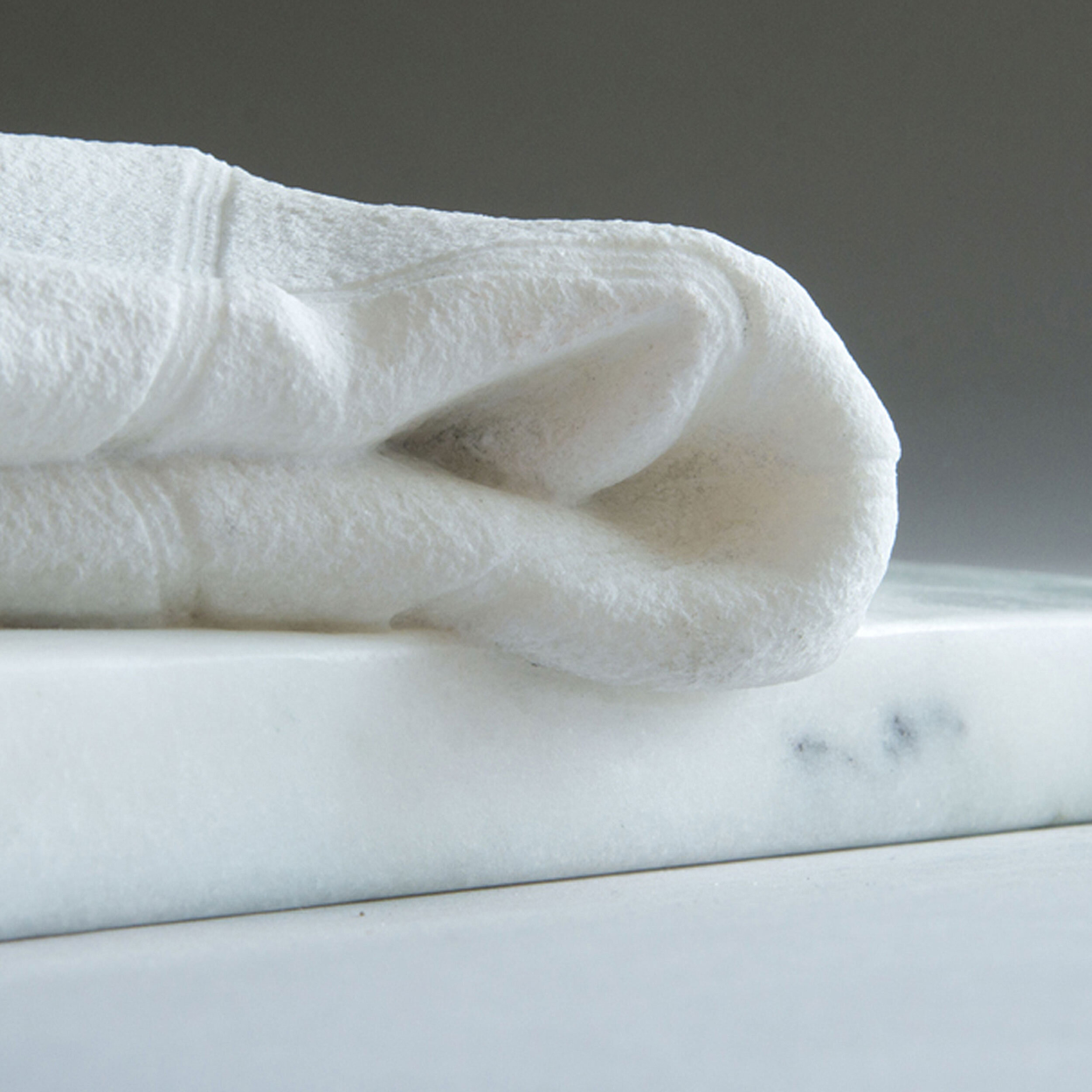 Detail of hand-carved marble towel, sculpted by Sebastian Martorana. 