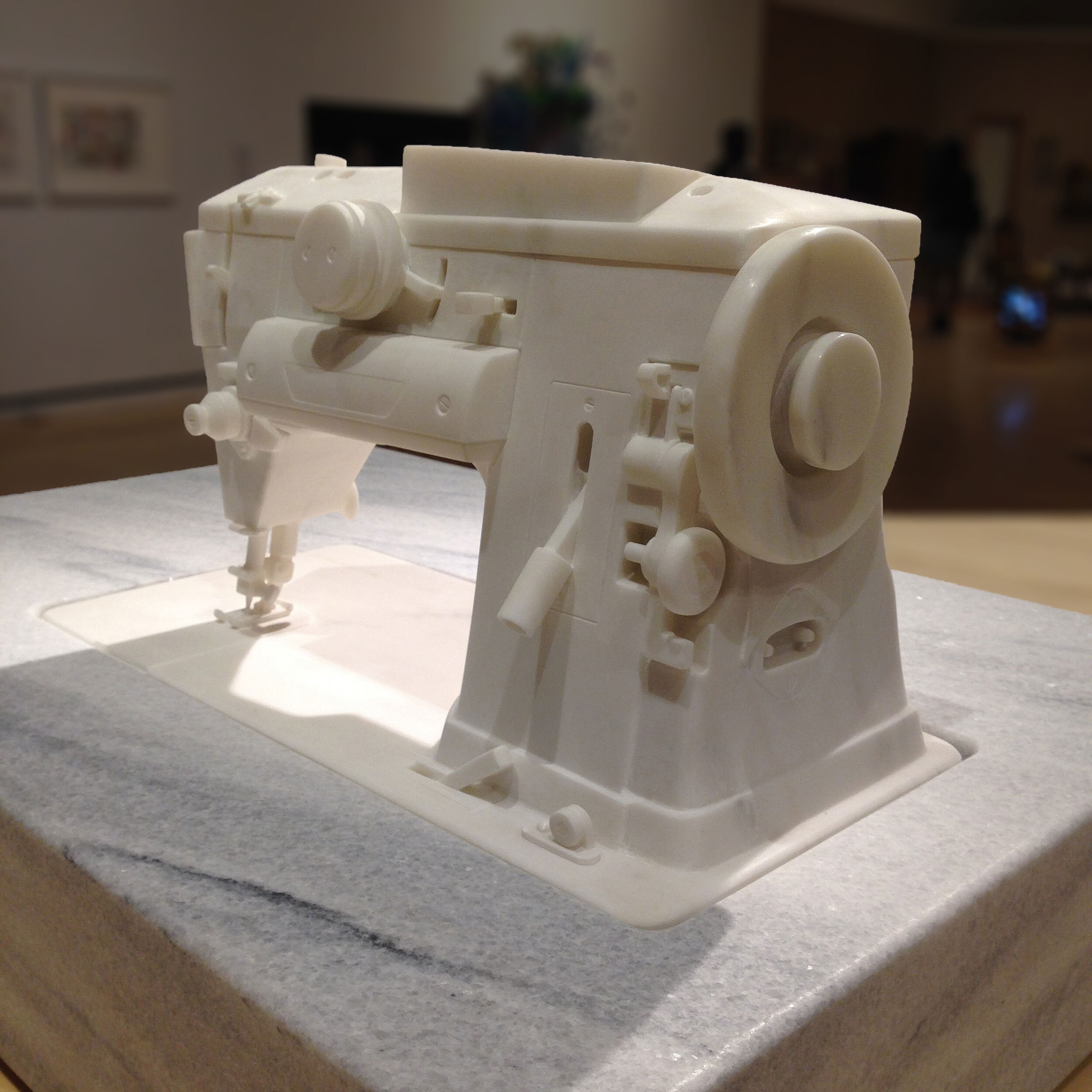 Hand-carved marble sewing machine sculpture by Peter Glenn Oakley.