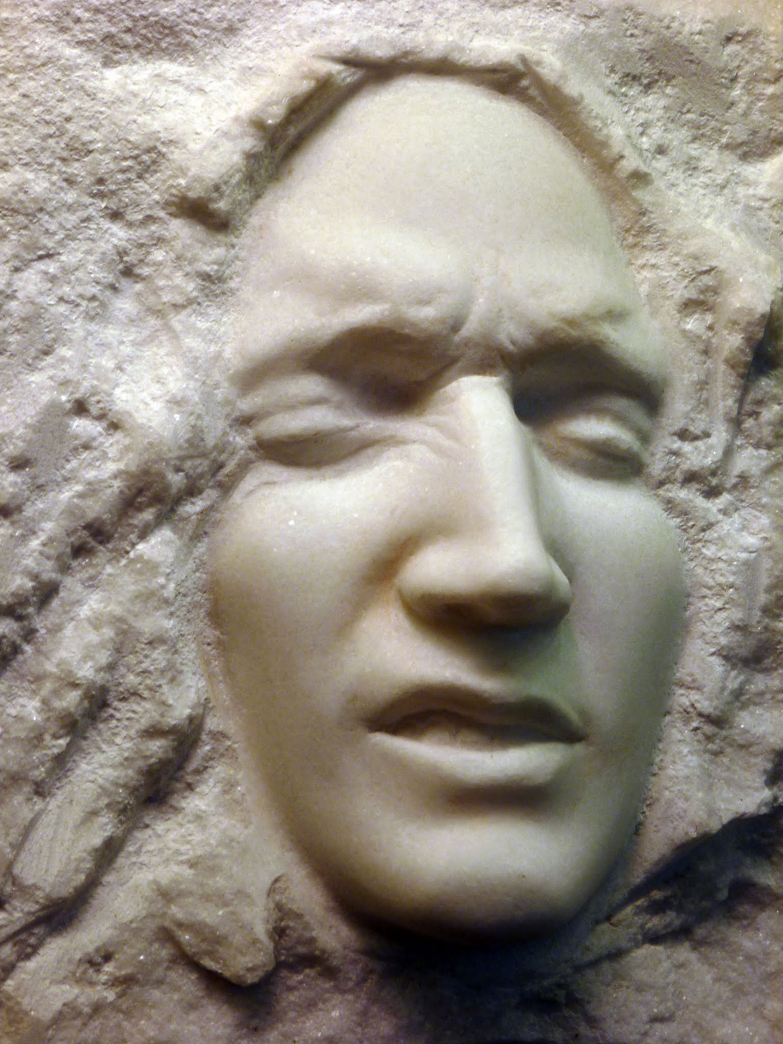Hand-carved stone sculpture of a face in Vermont Danby marble