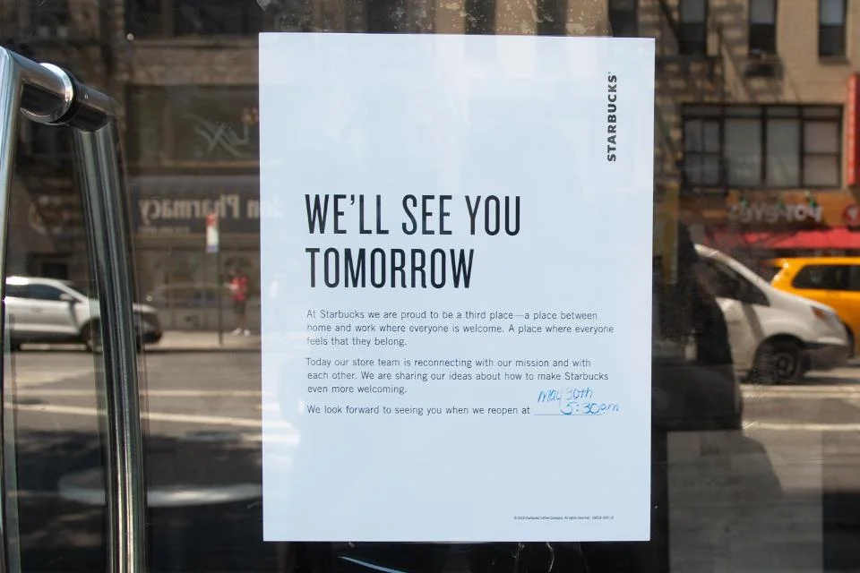 A sign in the window reports that Starbucks or store shut down for a racial predisposition preparation on May 29, 2018, in New York. - Starbucks is shutting in excess of 8,000 stores over the United States Tuesday to lead worker preparing on racial predisposition, a nearly watched practice that spotlights waiting issues of segregation across the country. (Photograph by Bryan R. Smith/AFP/Getty Images)