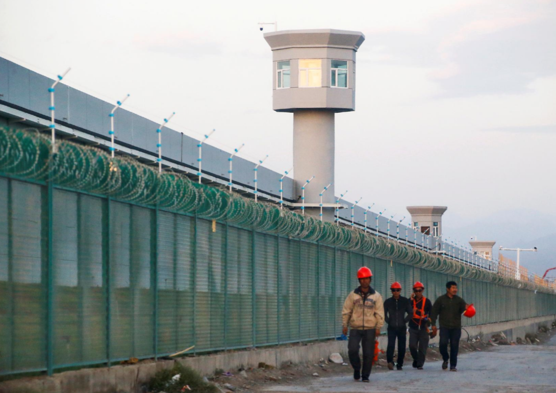 DOCUMENTED Image: Workers stroll by the edge fence of what is authoritatively known as a professional aptitudes instruction focus in Dabancheng in Xinjiang Uighur Autonomous Region, China September 4, 2018. REUTERS/Thomas Peter/File Photo