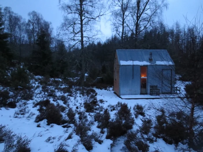 Inshriach Bothy in Inshriach Farm, Aviemore is tucked in a valley, the River Spey for soundtrack and the Cairngorms for a view. Even the frozen grass bows down to it in reverence.