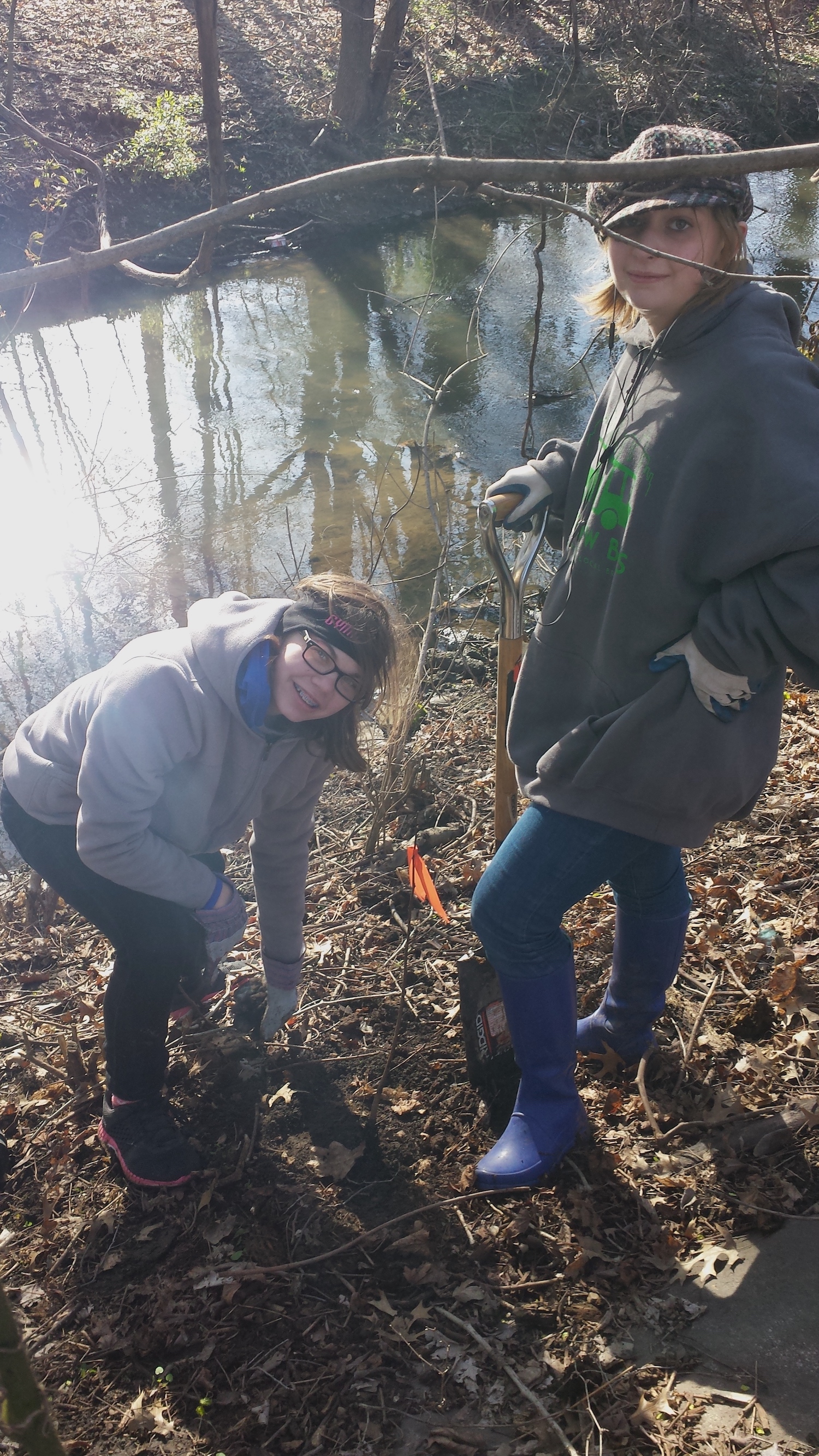 Abby and Lucy plant a tree.