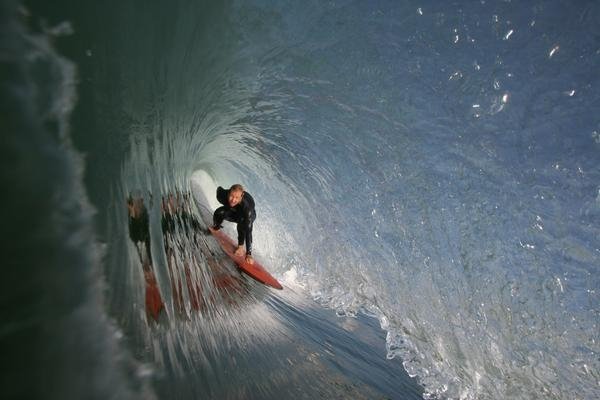 Photo of Brandon Russell featured in longboard Magazine riding a tudor single fin egg with a duct taped ding on the nose Photo: Joel Macks