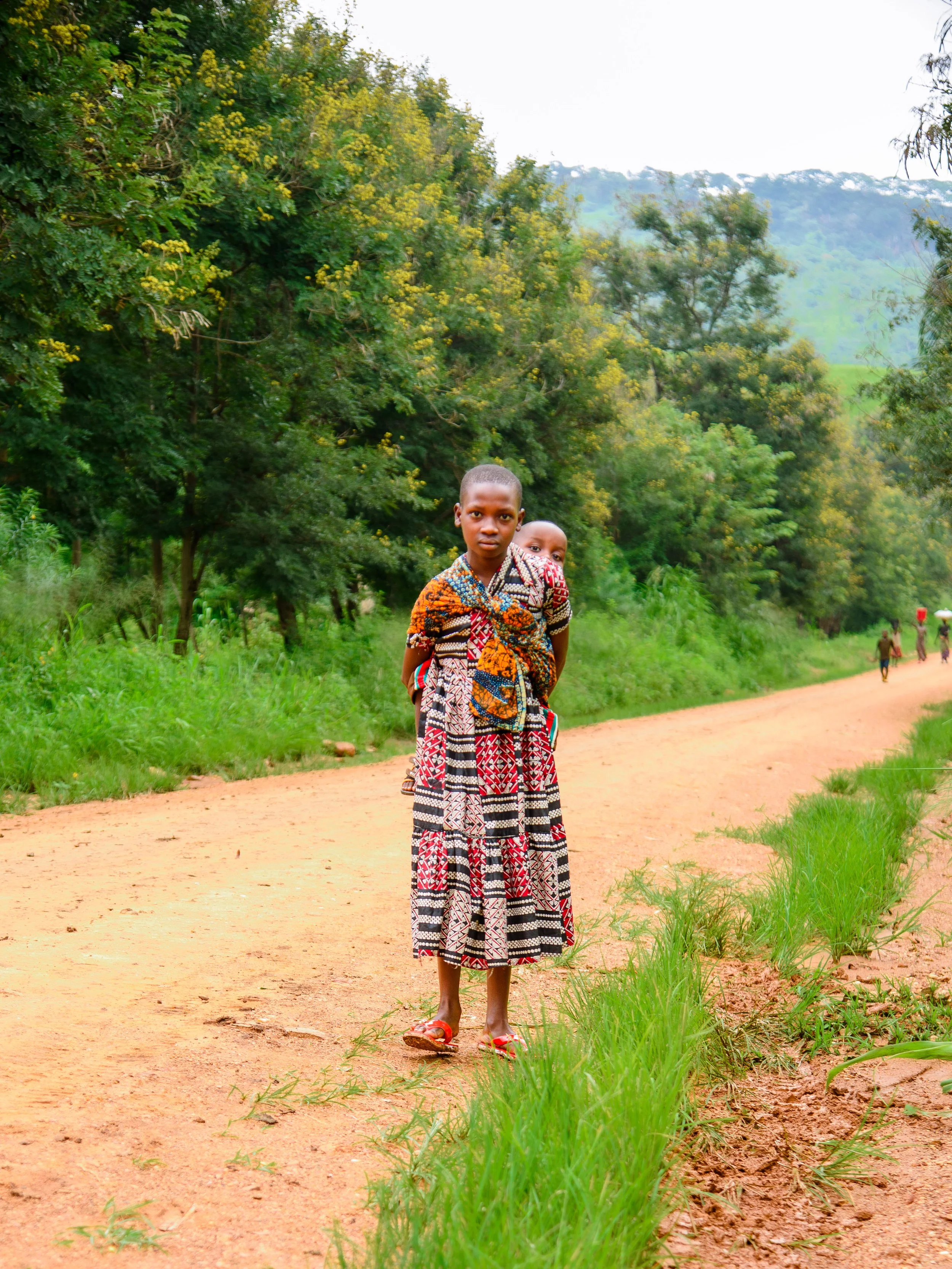 2026.03.01_A Child carrying a child on her back.jpg