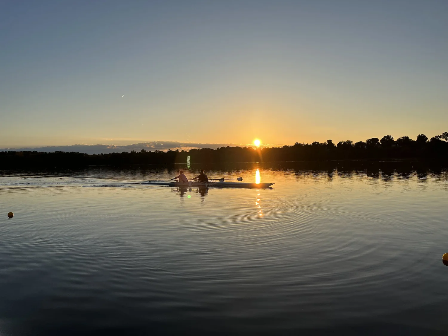 Two Rockland rowers in a double at sunrise on Rockland Lake