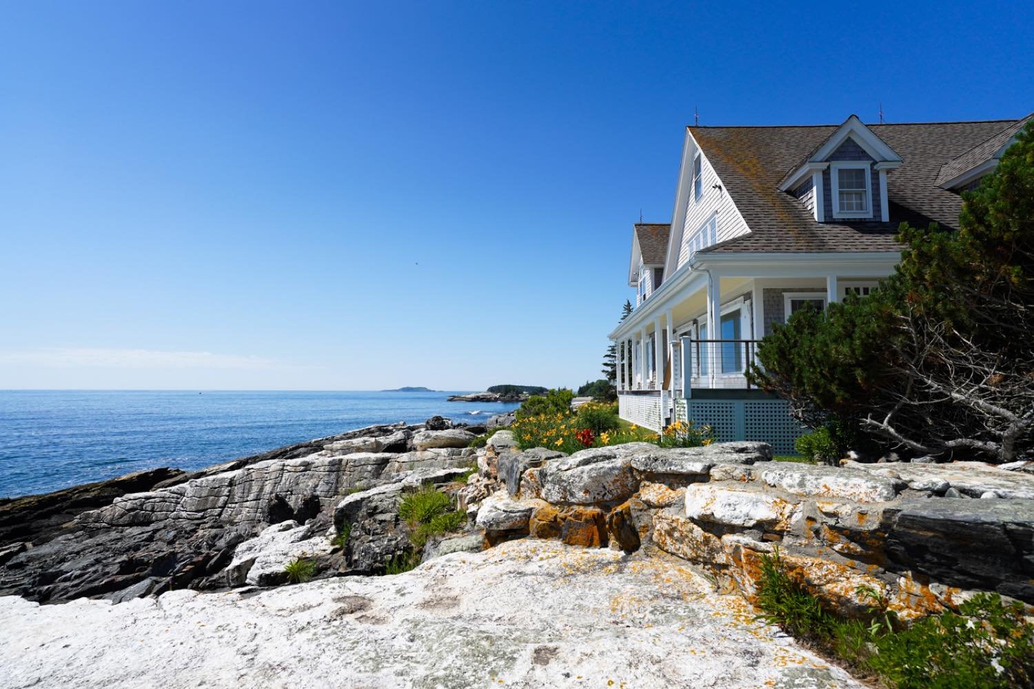  The quintessential coastal Maine home with stunning views to the Atlantic Ocean, pine covered islands and the iconic glacial rock slab the home sits on. A wrap around porch and the classic New England aesthetic complement this most ideal setting.  F