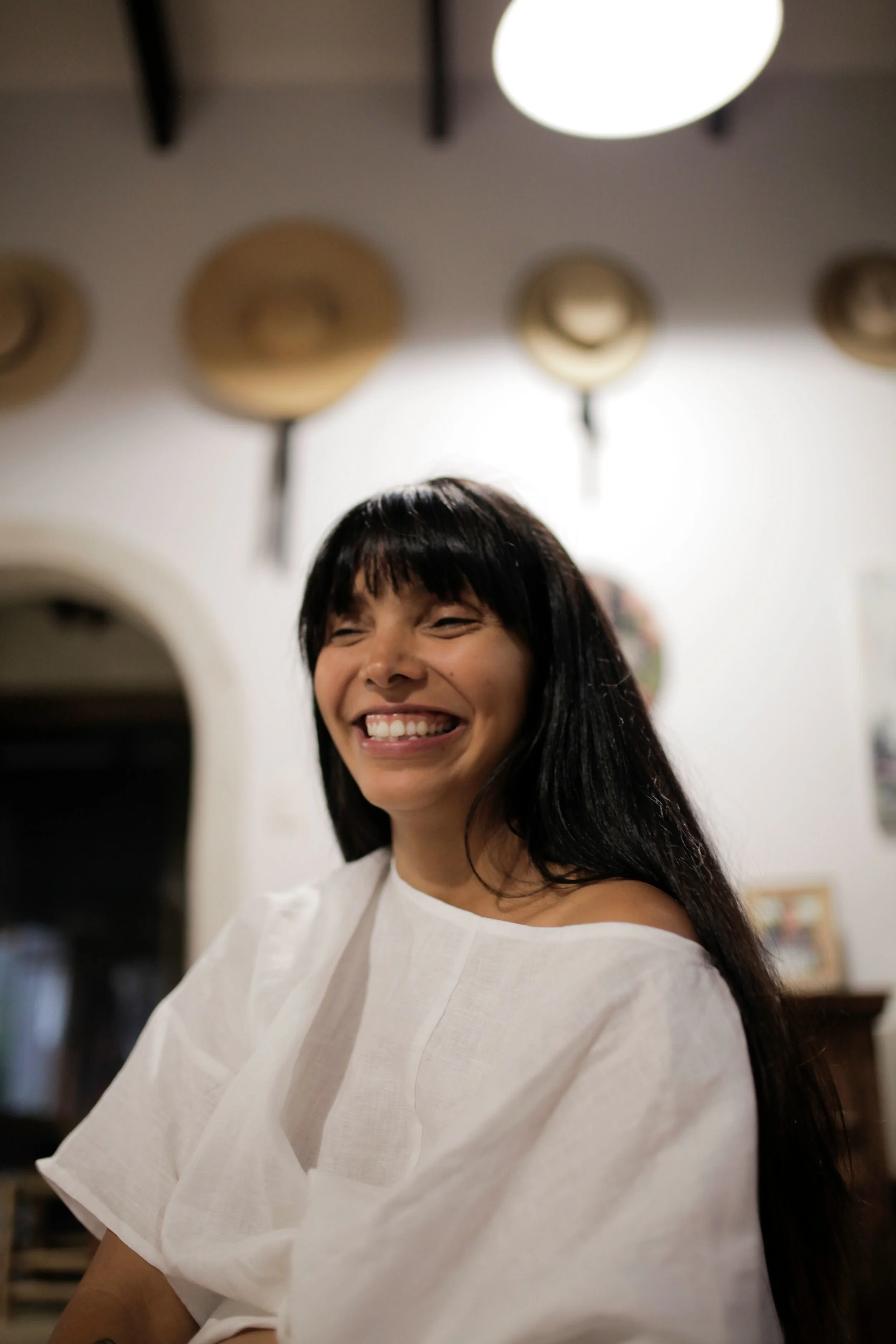 Nikita wears our Keiko Top in white linen