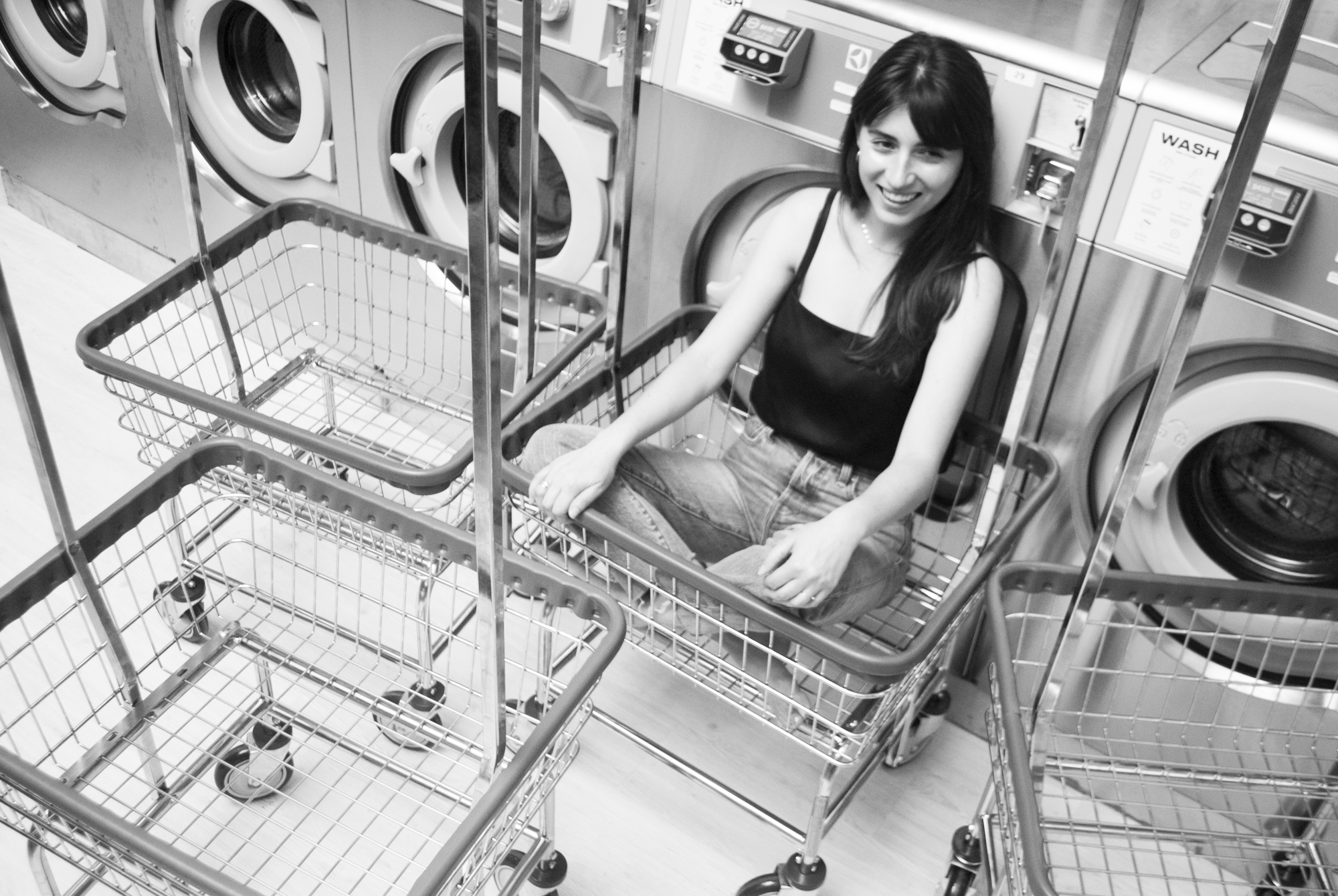 Ariana sitting peachy keen in her laundry dolly.
