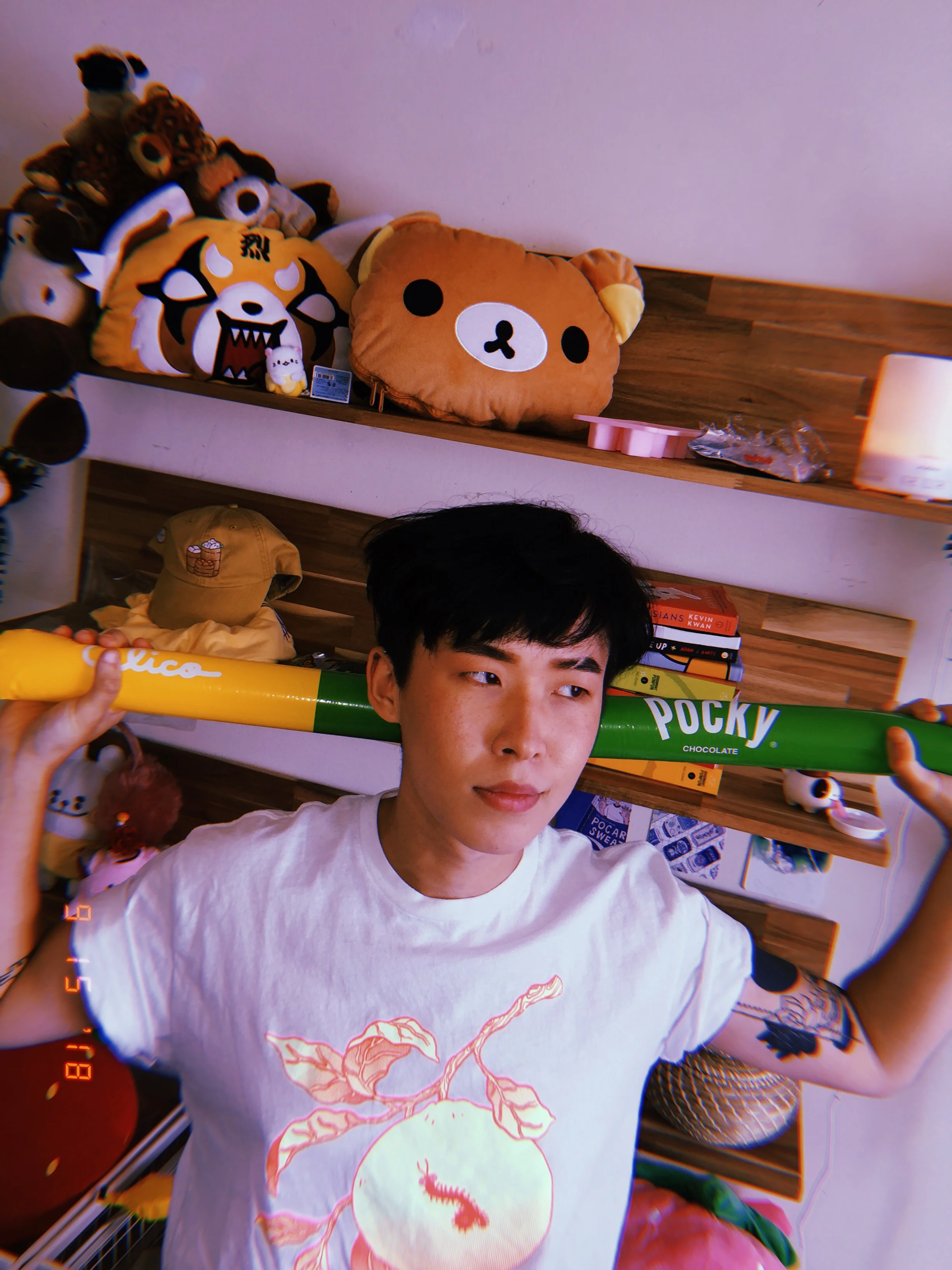 Wen in front of his various books and items.