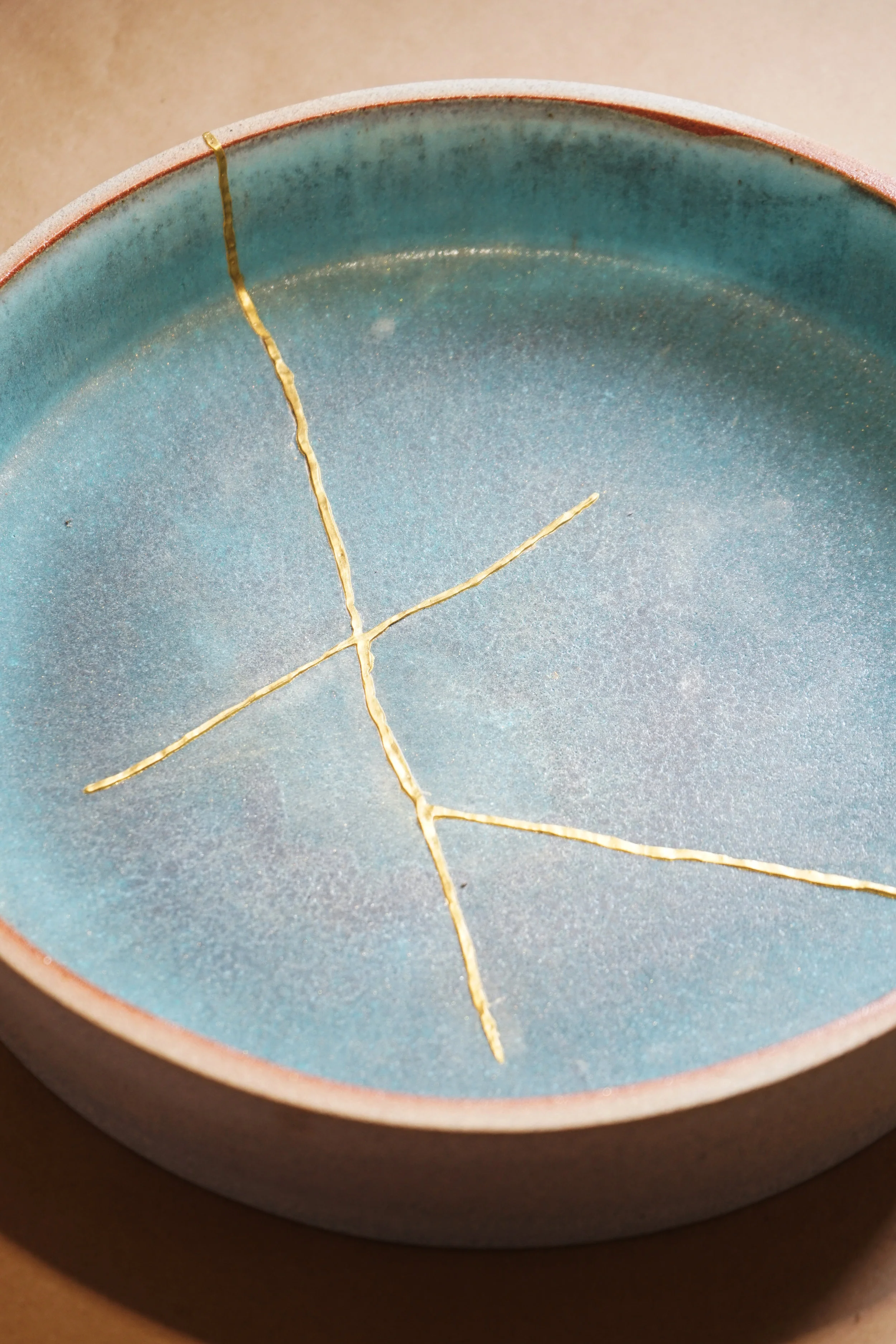 An example of the 24 karat gold binding on a broken bowl.