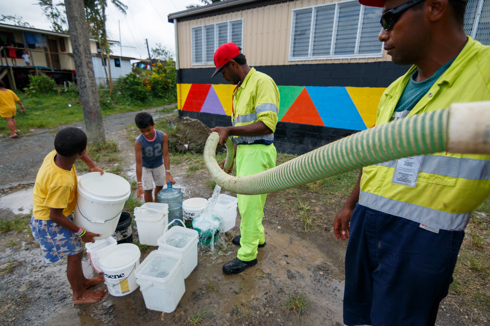  Workers from Suva's City Council fills residents' buckets with fresh water after power outages caused by Cyclone Winston stopped the pumps from working throughout Fiji's capital Suva, February 23, 2016. 