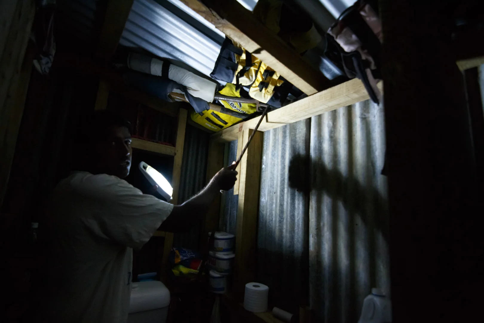 A resident from Nausori, Fiji, points to the emergency repairs he performed on his corrugated iron roof when it became dislodged and began to leak water after Cyclone Winston swept through the area on February 20, 2016.