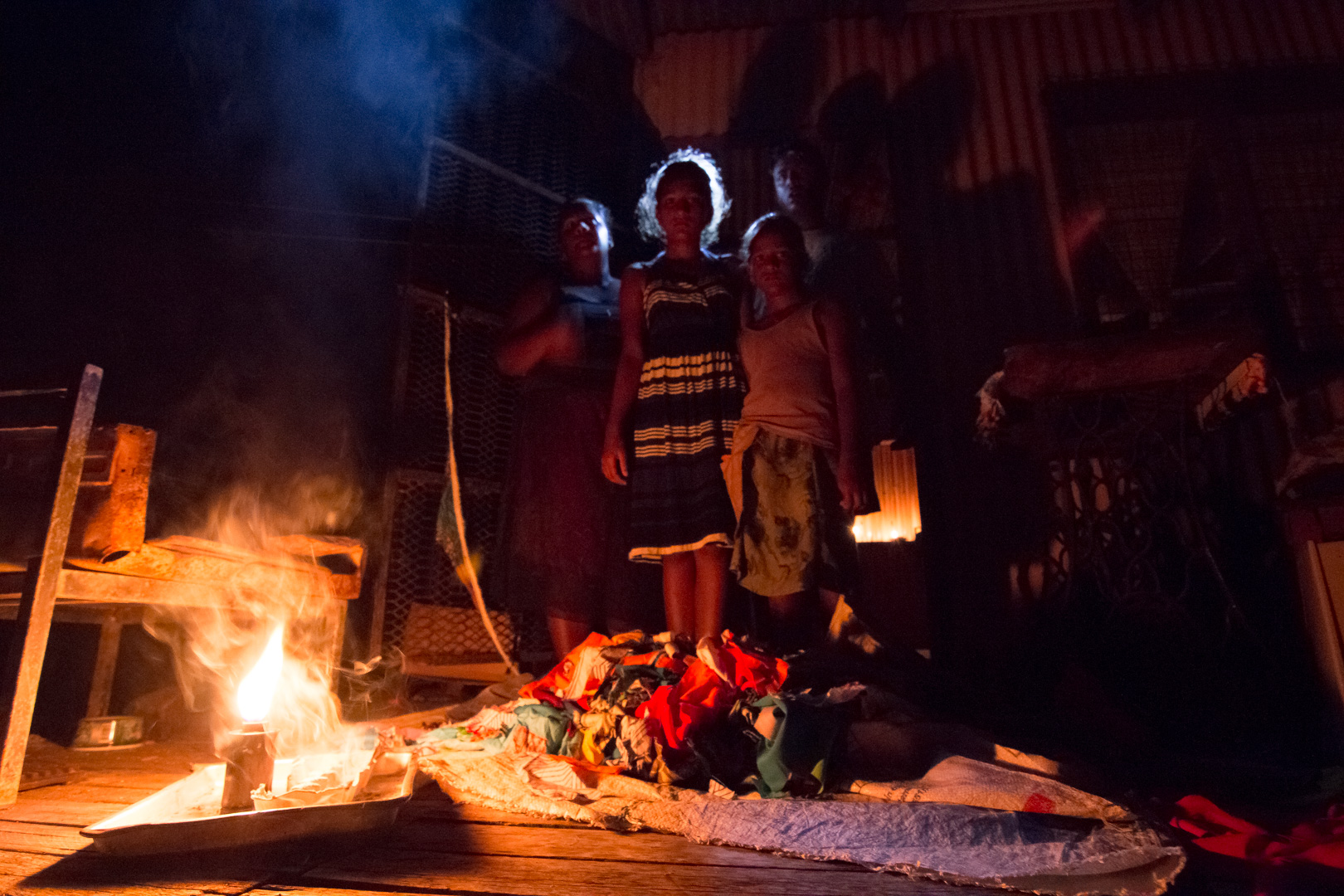  A family in Nausori spend the evening together without electricity due to nationwide power shortages caused after Cyclone Winston swept through the area and made landfall in Fiji on February 20, 2016. 