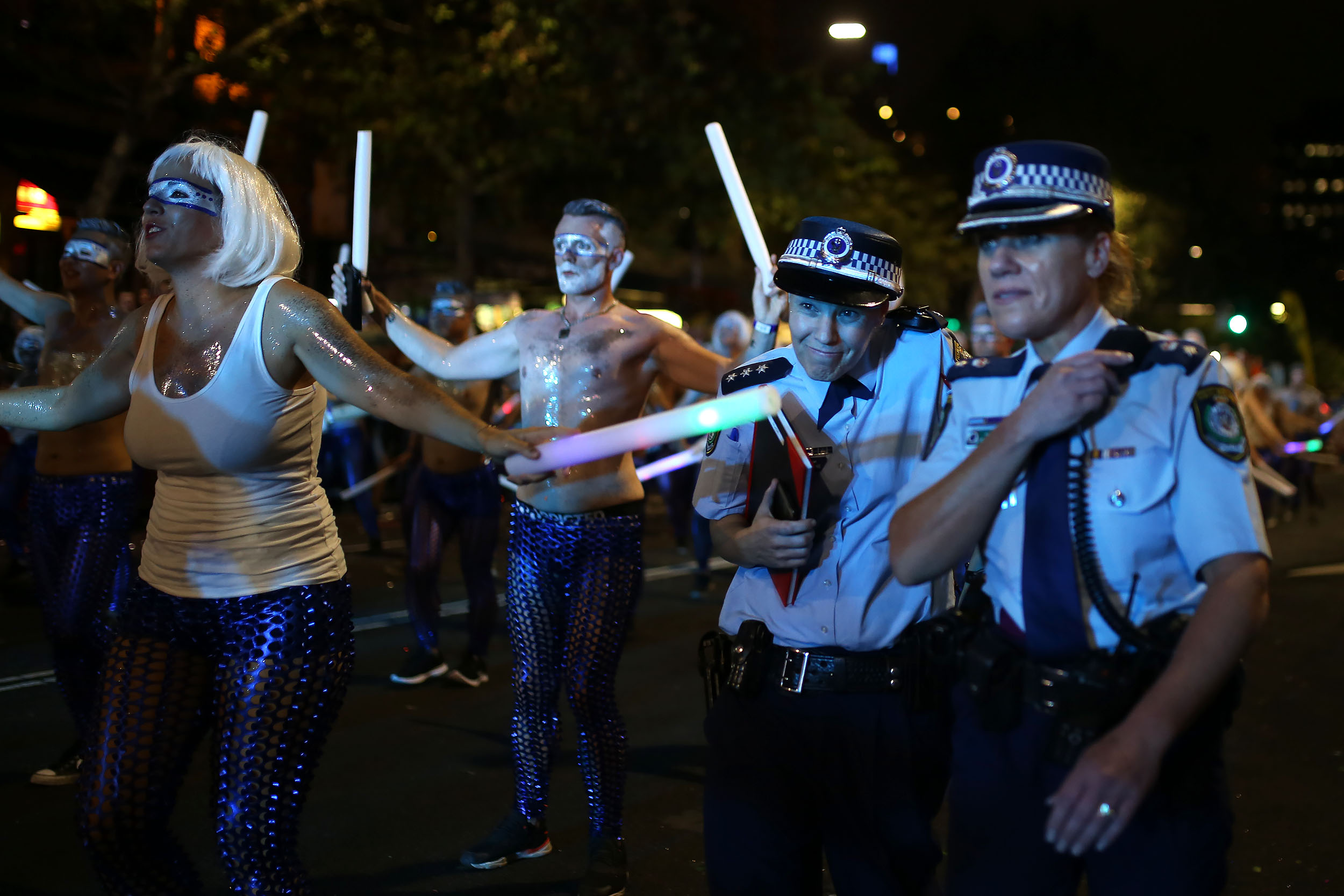  An Australian policewoman dodges a glow stick being waved by a participant during the annual Sydney Gay and Lesbian Mardi Gras parade in Sydney, Australia, March 4, 2017. 