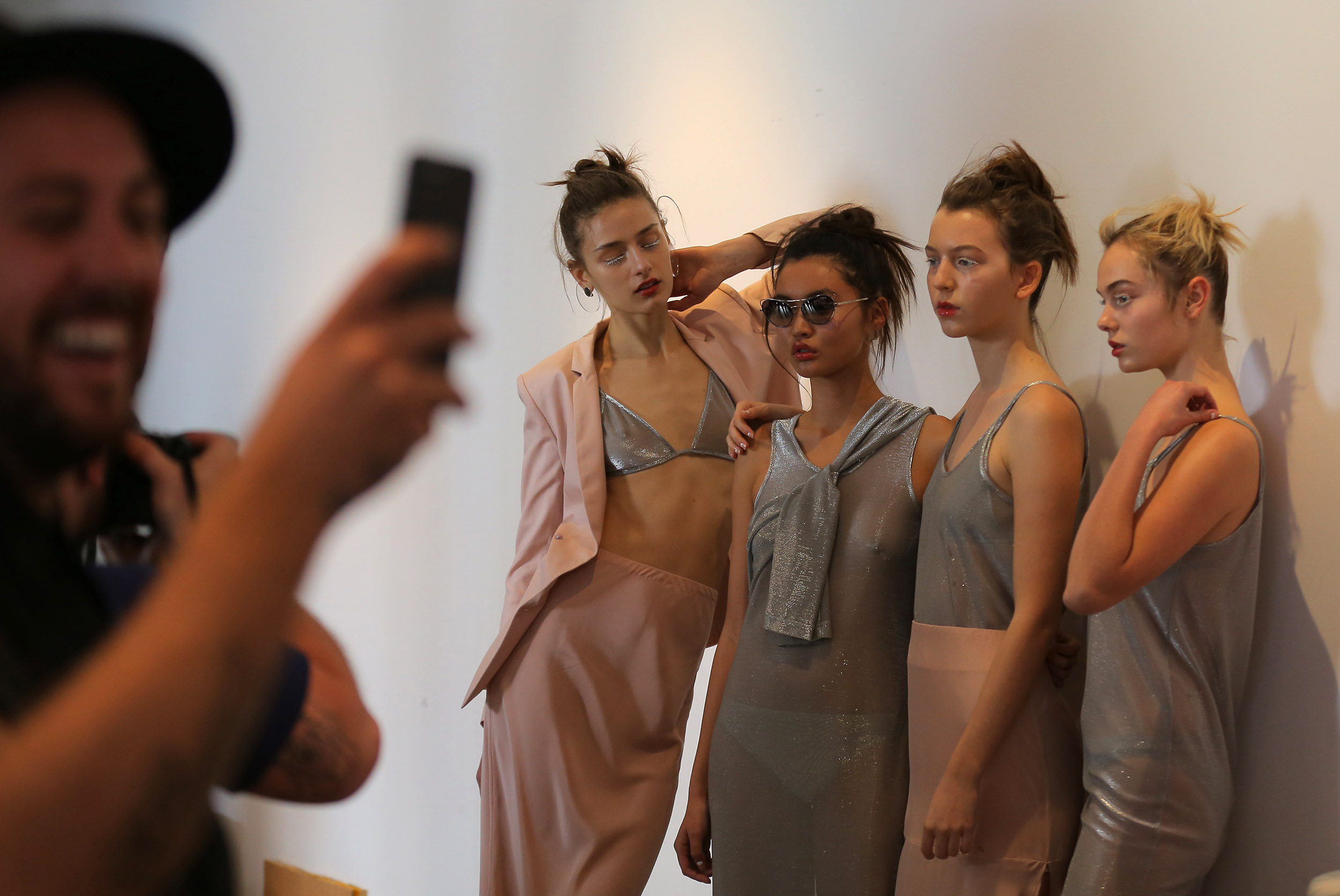  Models for designer Gary Bigeni pose backstage during Fashion Week Australia in Sydney, Australia. 