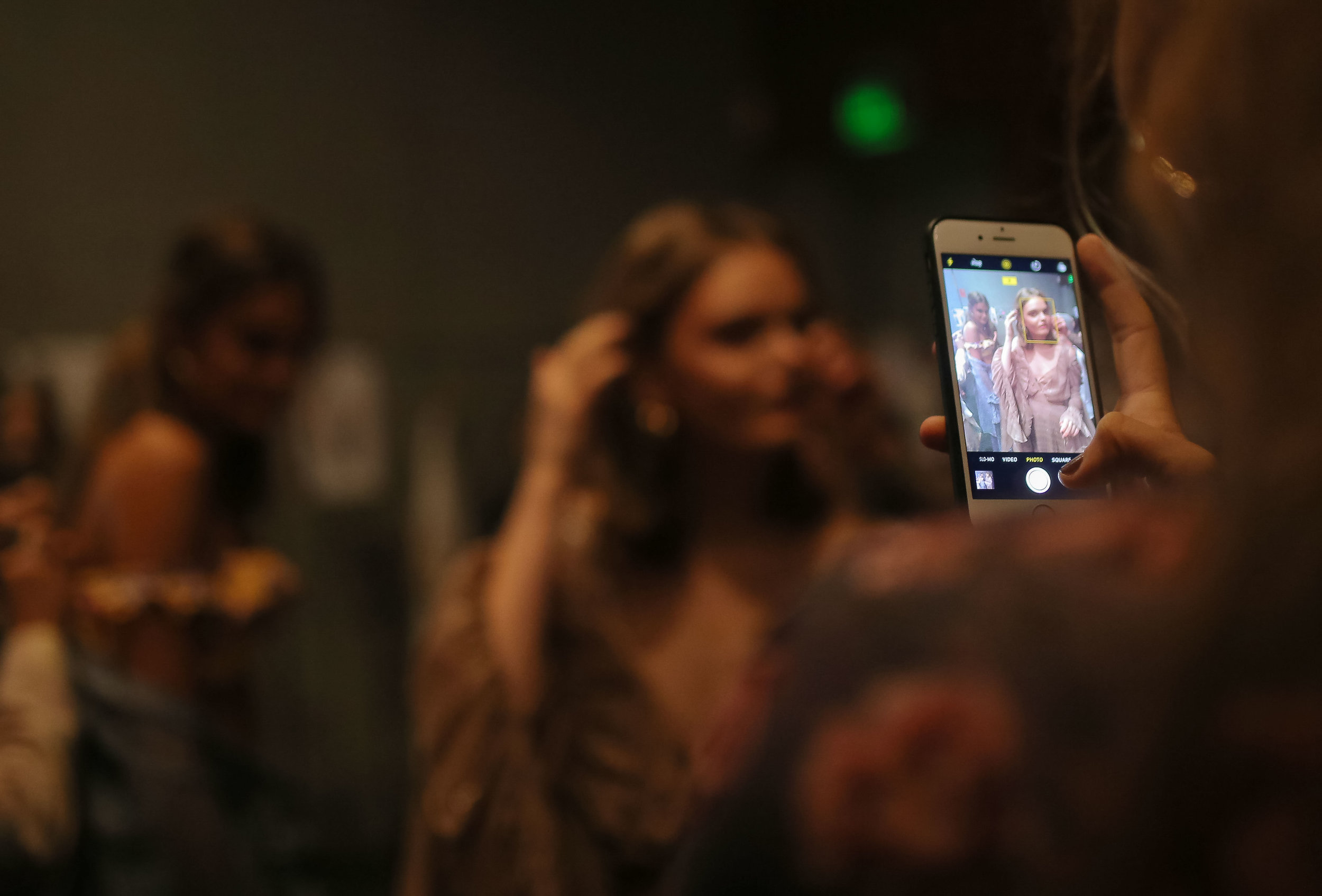  Models for We Are Kindred have a mobile phone picture taken back stage before a runway show at Fashion Week Australia in Sydney, Australia. 