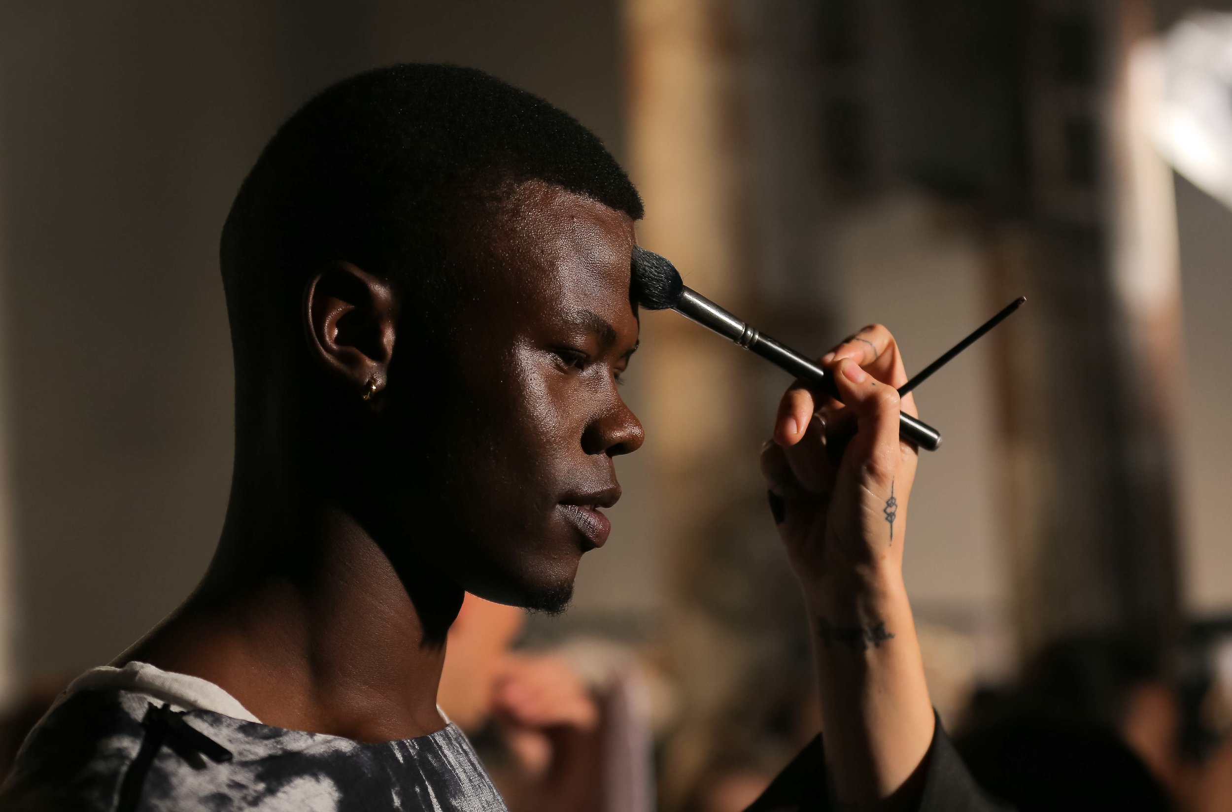  A male model in the ANX show has makeup applied back stage at Fashion Week Australia in Sydney, Australia. 