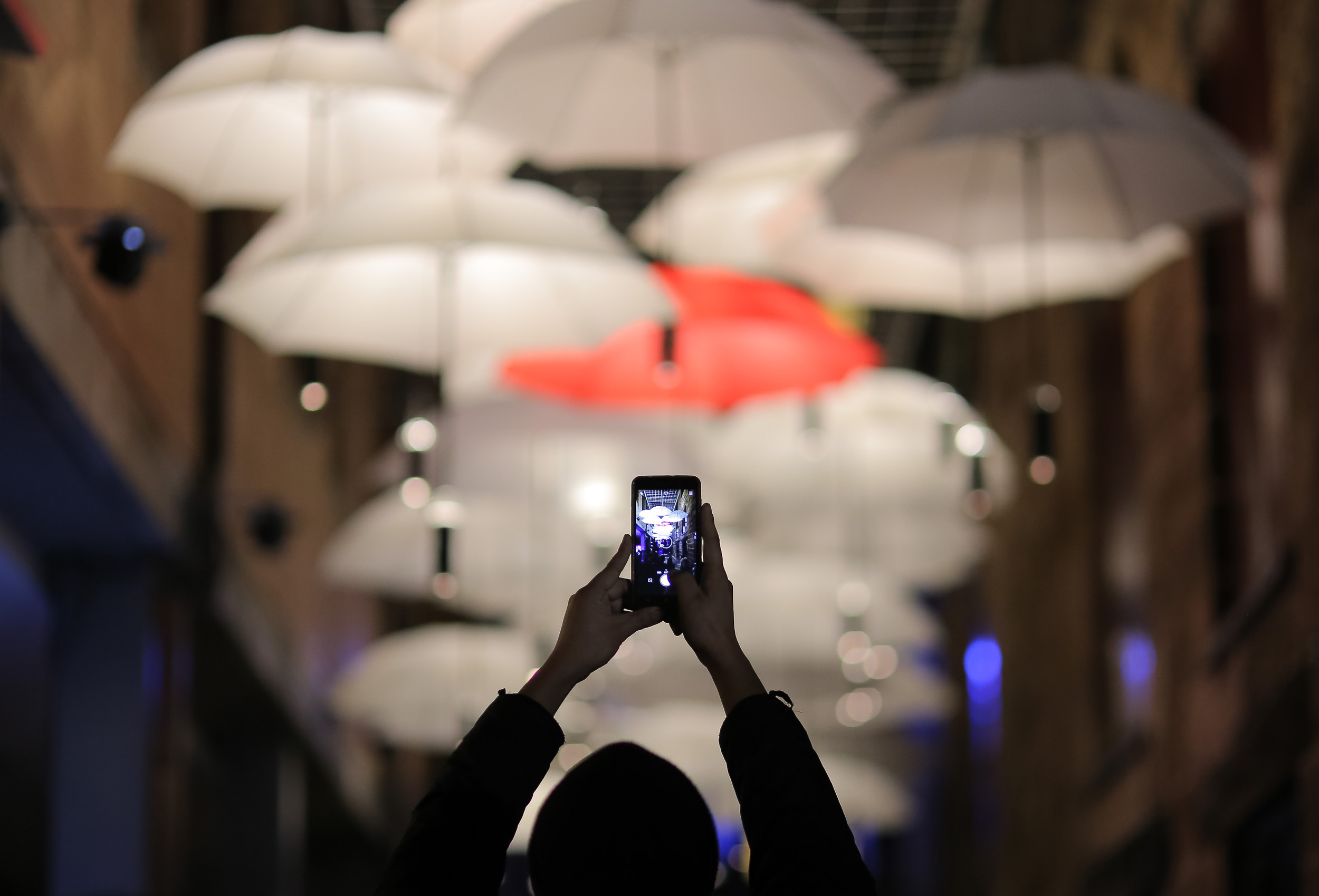  A member of the public takes a photograph of a canopy of umbrellas that are part of an installation titled 'Under My Umbrella' during the Vivid Sydney festival of light and sound in Sydney, Australia, May 27, 2017. REUTERS/Steven Saphore 