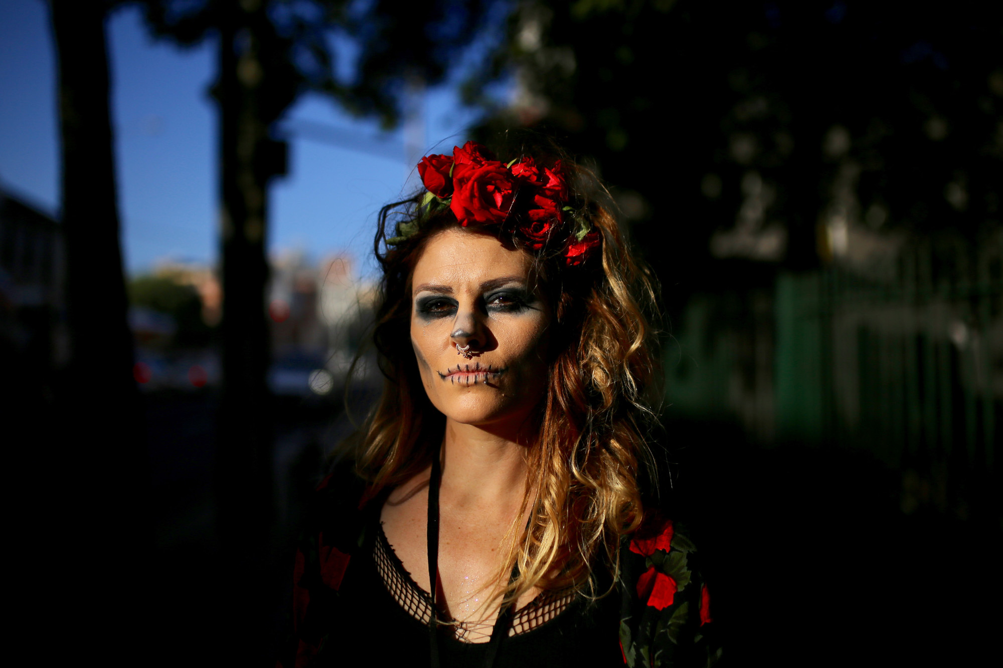  A woman wears makeup resembling a skull for Halloween in Newtown, central Sydney, Australia. 