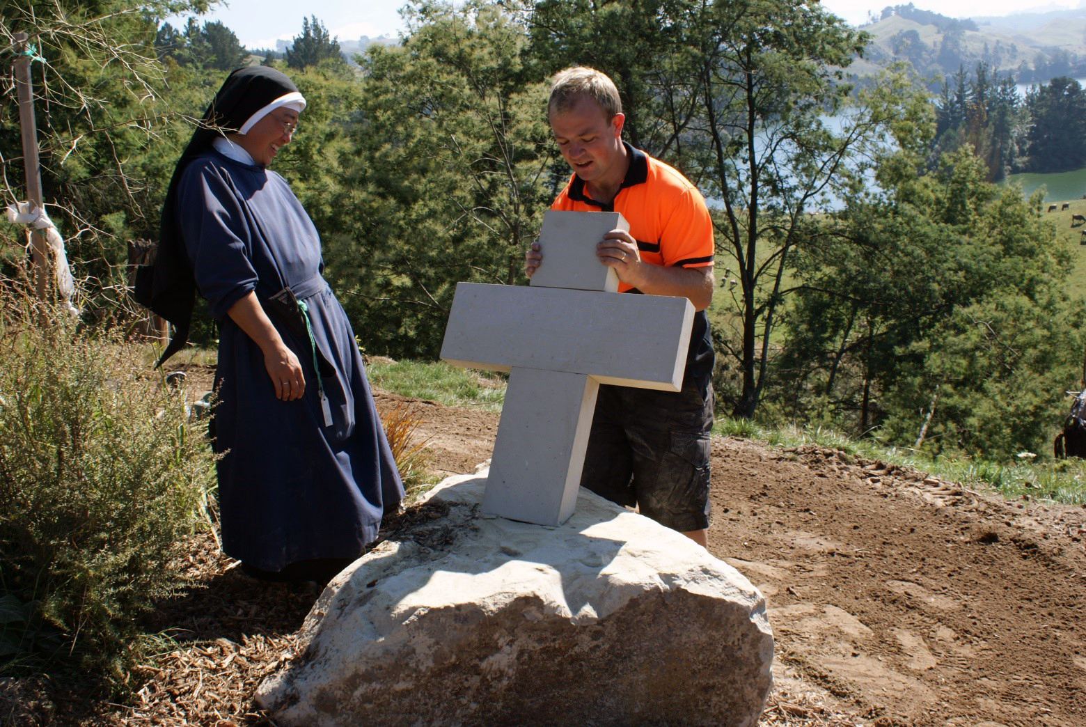 Matthew Skews finishing Hinuera Stone carving of a cross